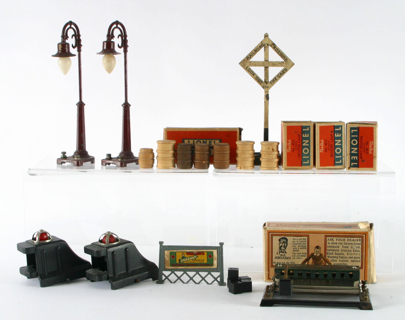 LIONEL, ETC. ACCESSORIES (10+): Metal, wood, glass and plastic; includes: (2) painted metal lamp posts; (1) German painted metal RR crossing sign; (1) metal with paper litho billboard sign; (1) Lionel Multi-volt Transformer No. 81 w