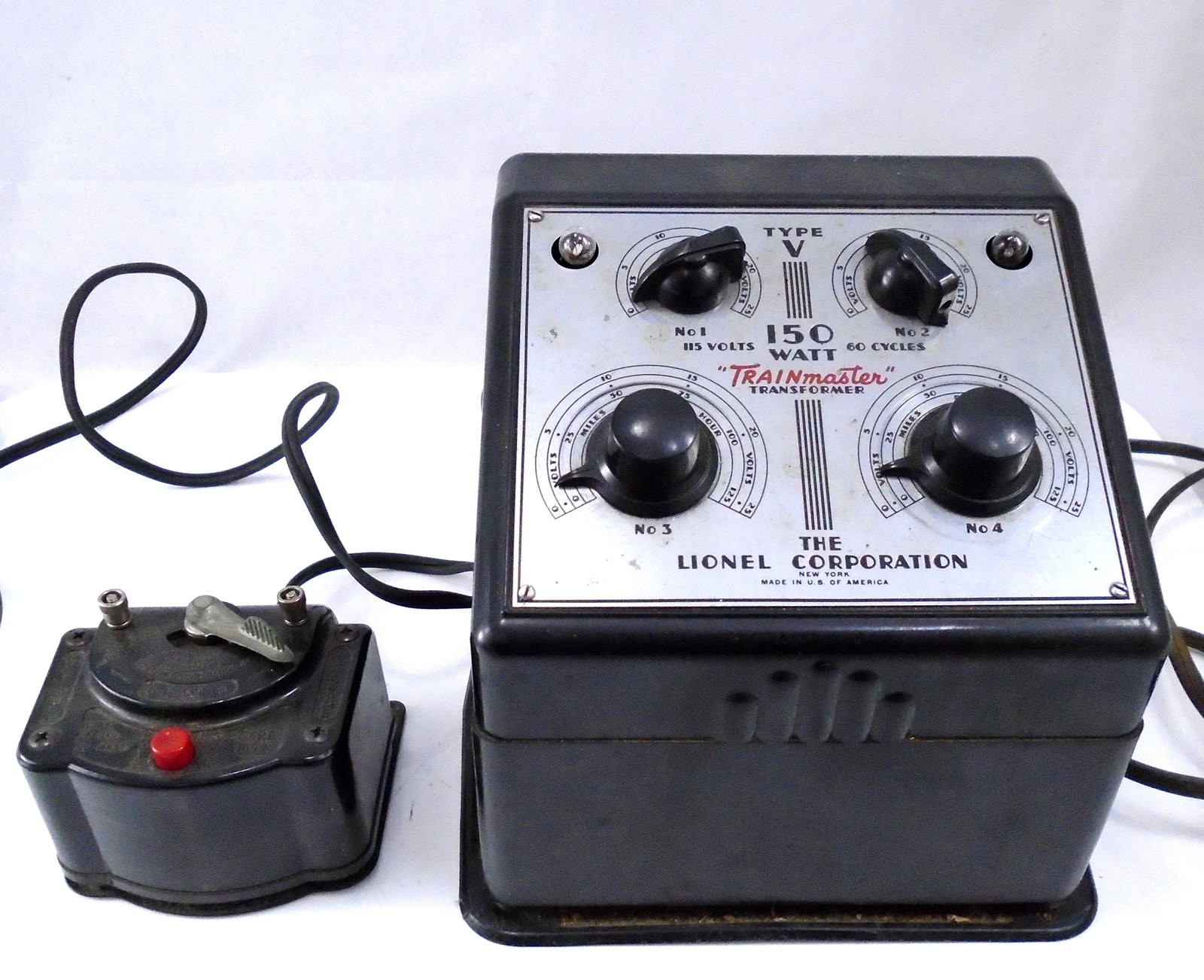 VINTAGE LIONEL TRANSFORMERS (2): Metal and plastic, Made in USA; (1) Trainmaster 150 watt type V No. 1: 115 volts, No. 2: 60 cycles; (1) Multivolt 8-17 volts type 1053; longest 8";