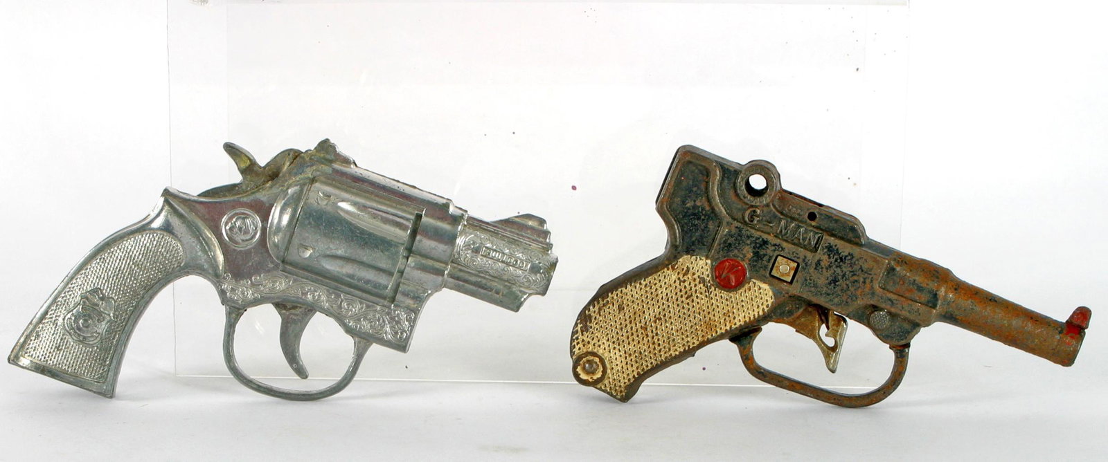 (2) VINTAGE CAP GUNS, KILGORE, ETC.: (1) Vintage metal snub-nose cap gun .38; Police badge on grips; L-6"; (1) Kilgore iron G-Man cap gun, white grips and red (K); L-5 1/2";