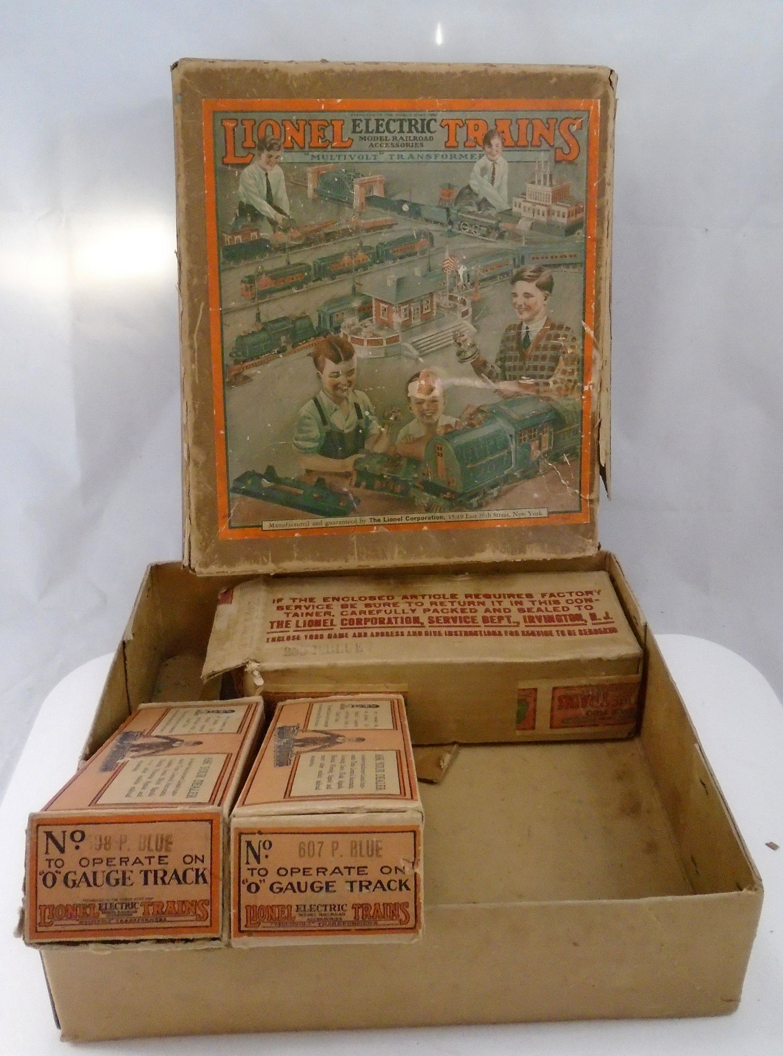 VINTAGE LIONEL TRAIN BOXES (EMPTY) (4): paper litho / cardboard; (1) Set box No. 296 for "O" gauge track, (1) 253 P. Blue shipping box; (1) 607 P. Blue, (1) 698 P Blue; largest box: 15 1/4" x 13";
