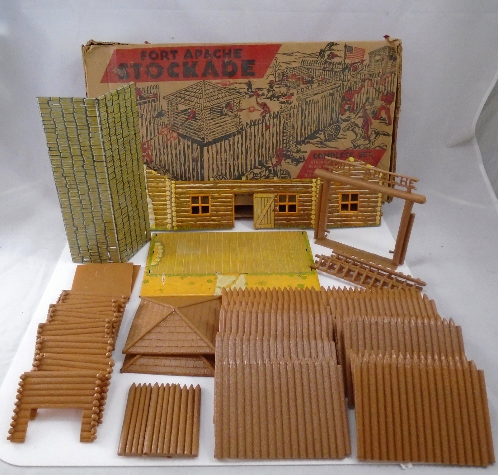 MARX FORT APACHE STOCKADE TOY: Retains original box; Plastic and tin litho; 1950's; tin litho and stockade pieces appear to hardly have been used; incomplete; no figures / furniture / accessories; box L-21 1/4";