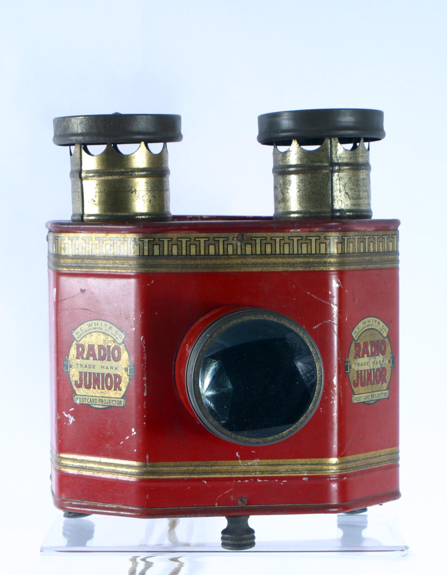 H. C. WHITE RADIO JUNIOR POSTCARD PROJECTOR: Tin litho with central lens, two electric light bulbs illuminate the cards; lights; 9" x 9" x 11";