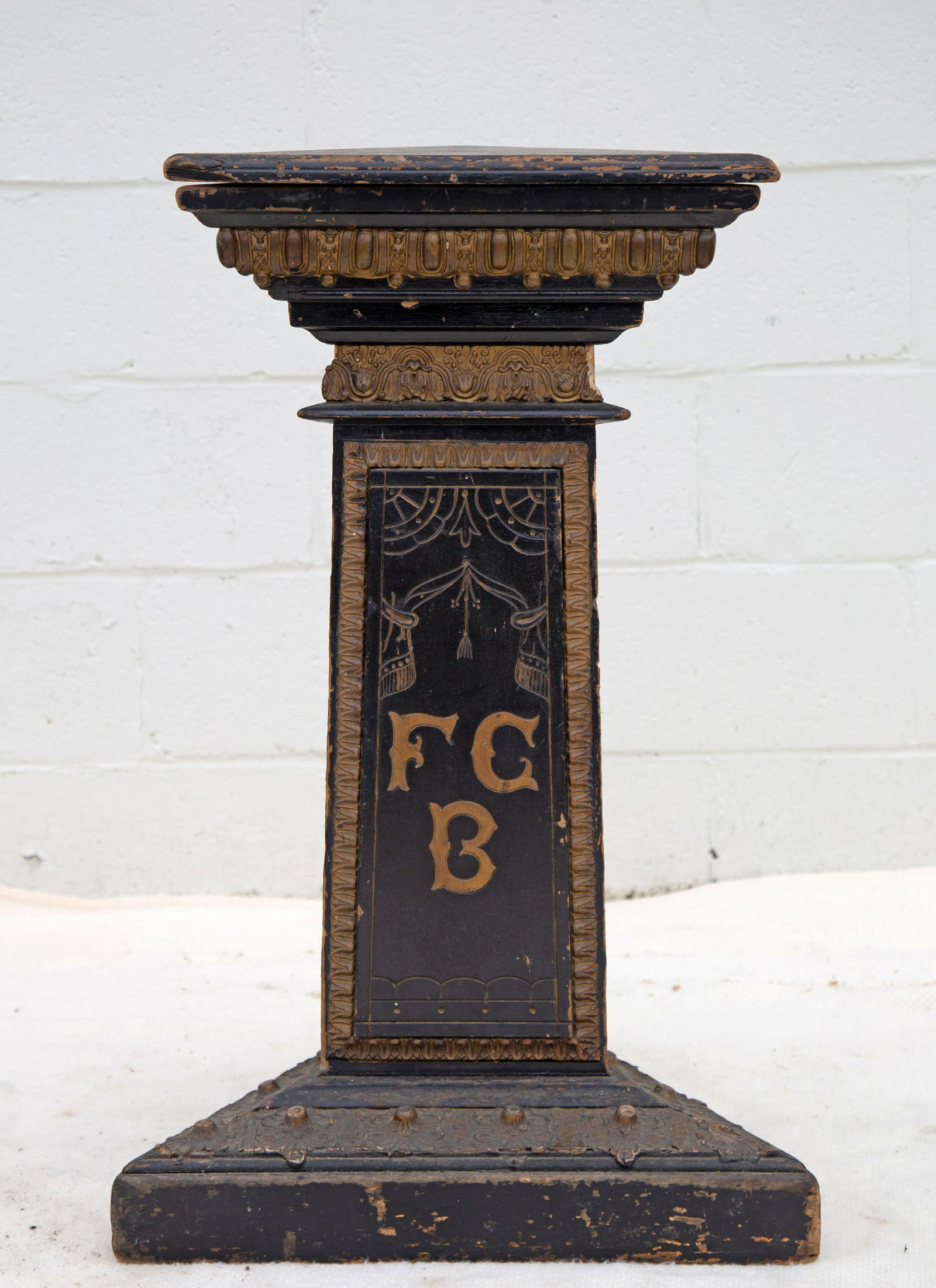 FRATERNAL PEDESTAL: Triangular form; painted wood with applied embossed gesso ornaments, some gesso loss and damage, corner losses; FCB (Knights of Pythias) on side, H-32", Width 20 1/2", G+