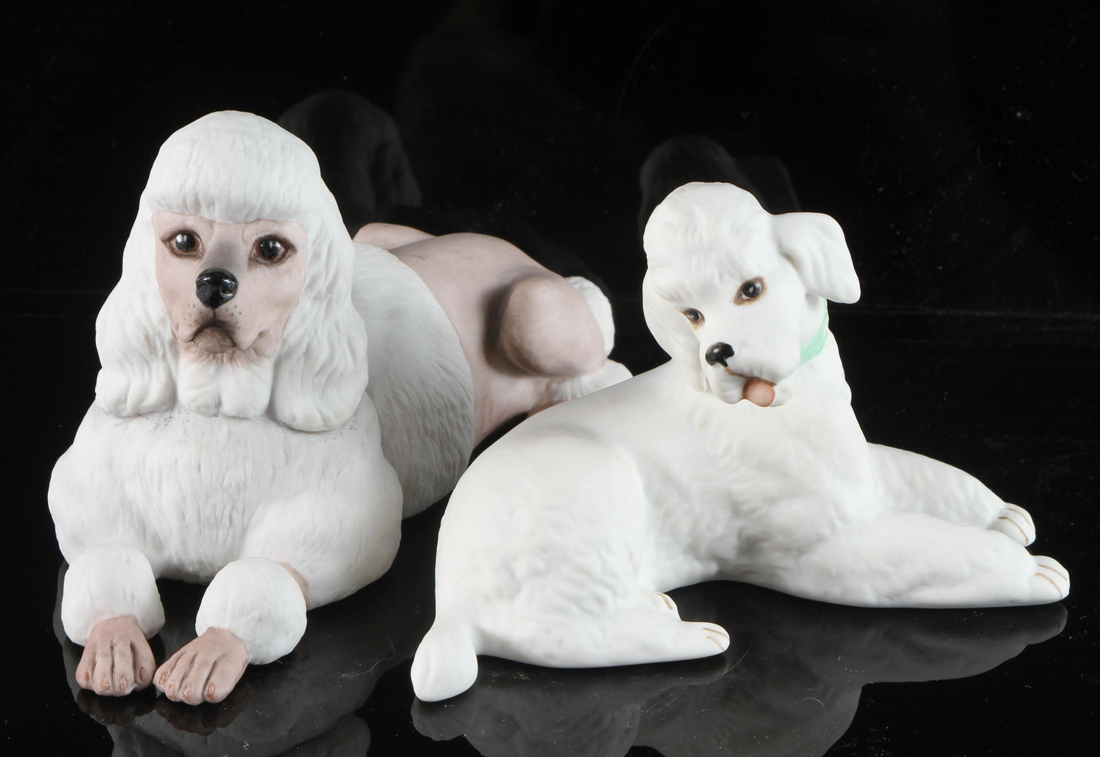 (2) BOEHM PORCELAIN POODLES: Both reclining; (1) with painted signature; (1) with stamped signature; longest L-6 1/2", VG-EX