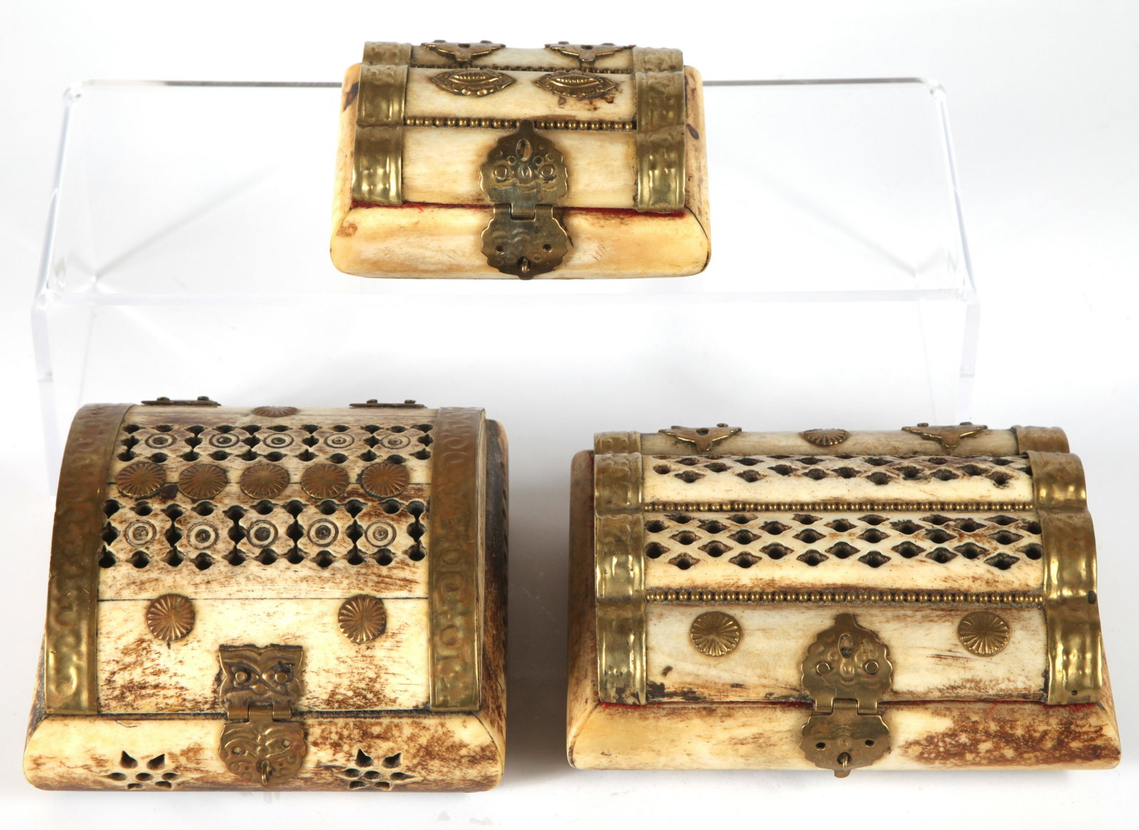 (3) BONE COVERED TRINKET BOXES: Rectangular with domed tops; bone covered with brass fittings, (2) with a perforated lid and sides; brass hasp; velvet lined; graduated sizes;