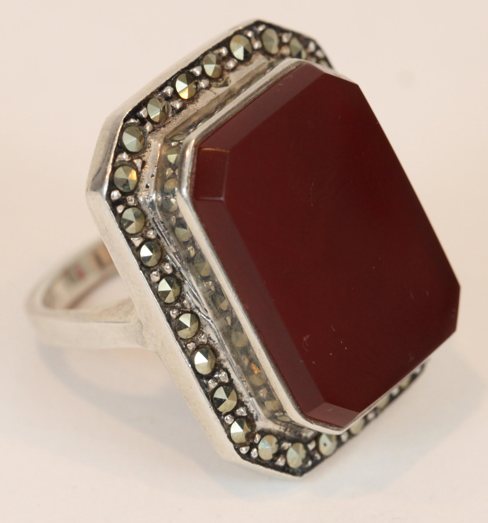 LARGE STERLING CARNELIAN & MARCASITE RING: Bezel set carnelian stone approx. 15 mm x 19 mm, surrounded by marcasite stones; size 6.5; stamped 925 NF, .39 ozt total, VG-EX