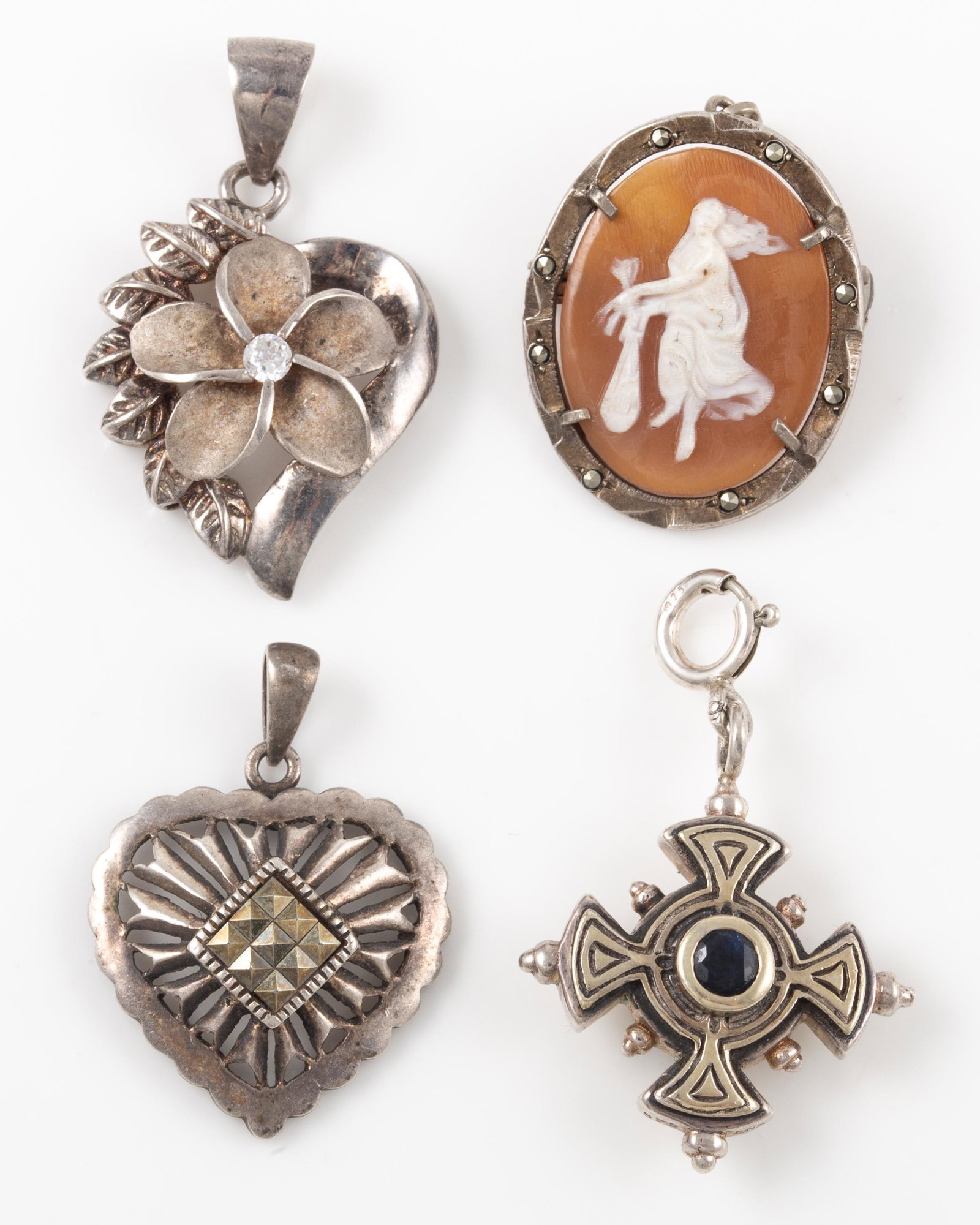 (4) PCS. STERLING PENDANTS: Includes: (1) reticulated heart pendant, set with marcasite, marked HAN; (1) floral pendant, set with clear stone; (1) cameo pin / pendant; full standing figure, marcasite bezel; (1) Maltese cross for