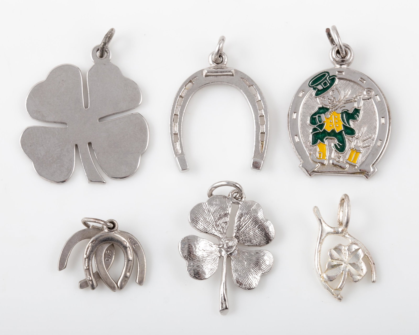 (6) STERLING LUCKY CHARMS: Includes: (2) four leaf clovers, (1) enameled leprechaun - slides open to reveal Irish prayer; (1) wishbone with clover, (1) horseshoe, (1) triple horseshoe, [.47 ozt total], sizes, 3/4"-1 1/8", EX