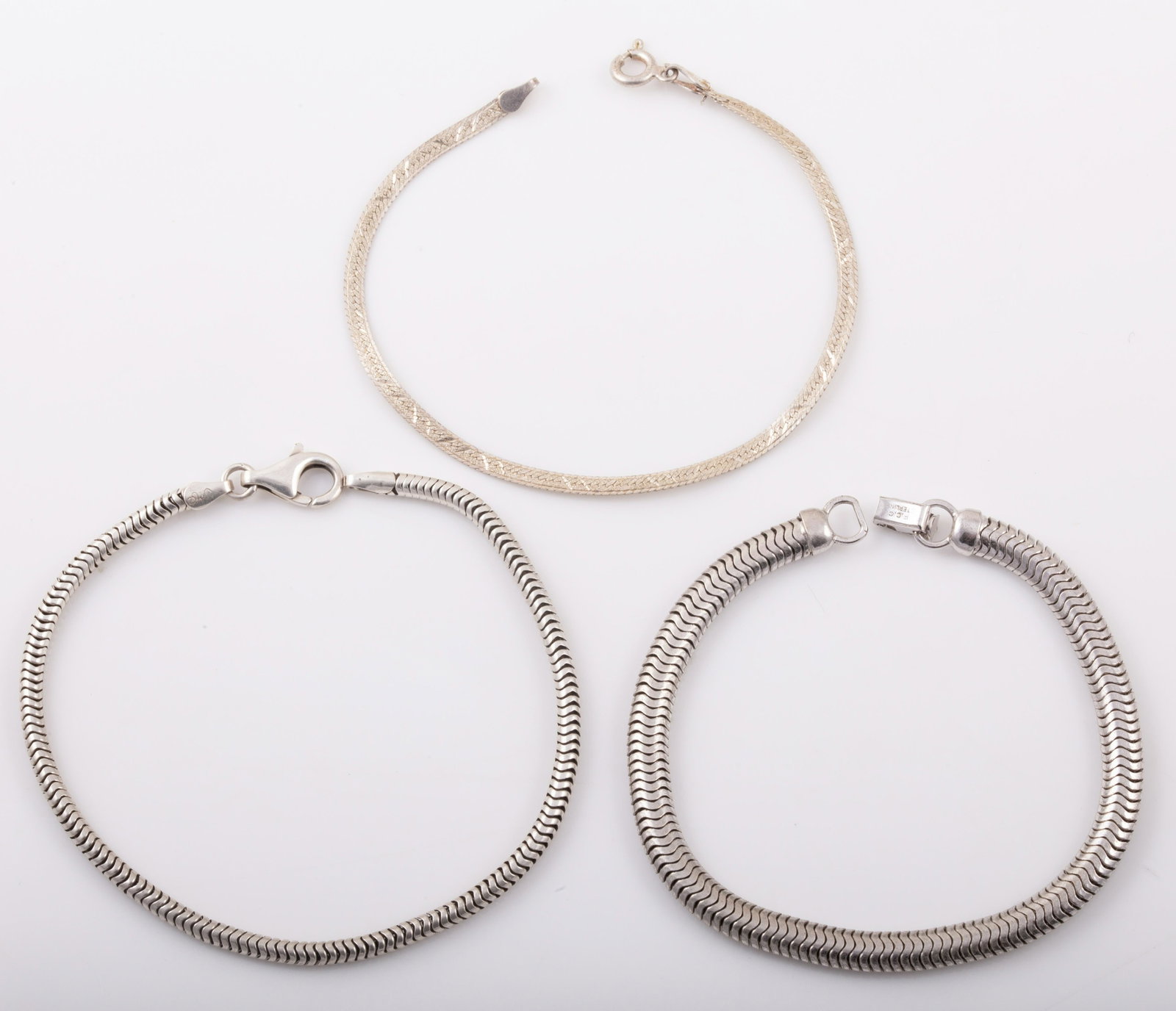 (3) STERLING BRACELETS: (1) 1/4" Wide F.C.C. snake chain, L - 7 1/4", .48 ozt; (1) 1/8" Wide Italian snake chain L - 8 1/4" , .23 ozt; (1) Italian flat chain L - 7 1/4" , .06 ozt; ( .78 ozt total for all) minor wear. G - VG