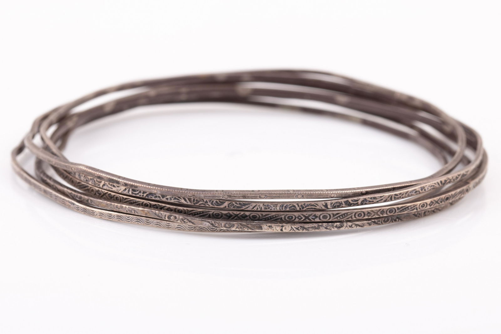 (6) THIN STERLING BANGLES: Etched design thin bangles, 1.5 mm wide, 8" circumference; somewhat misshapen; [.50 ozt total]; overall G-VG