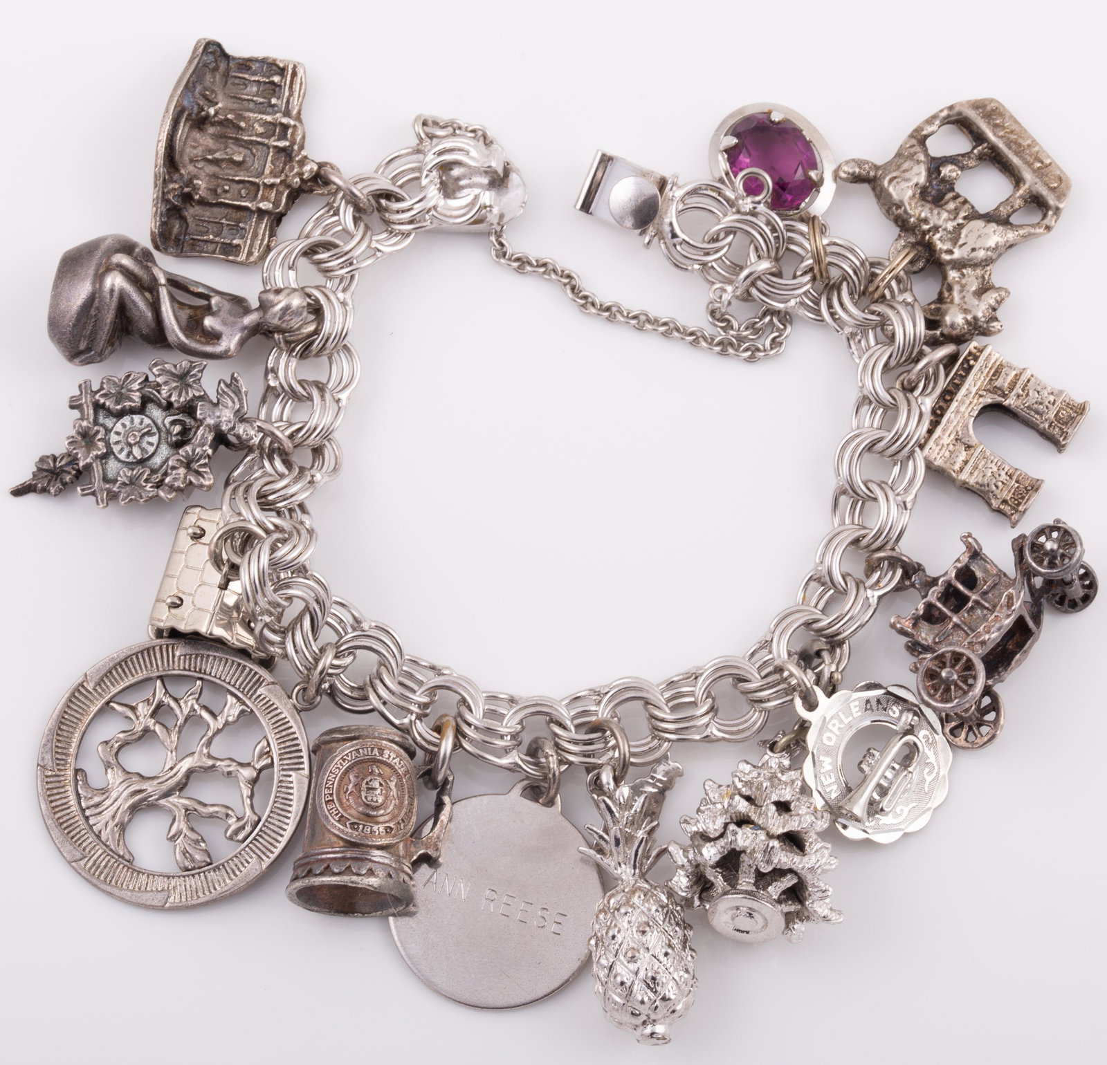 STERLING CHARM BRACELET: 14 Charms: Christmas tree, tree of life, cabin, cuckoo clock, stein, pineapple, car, travel, etc.; 2.48 ozt L - 7" G - VG