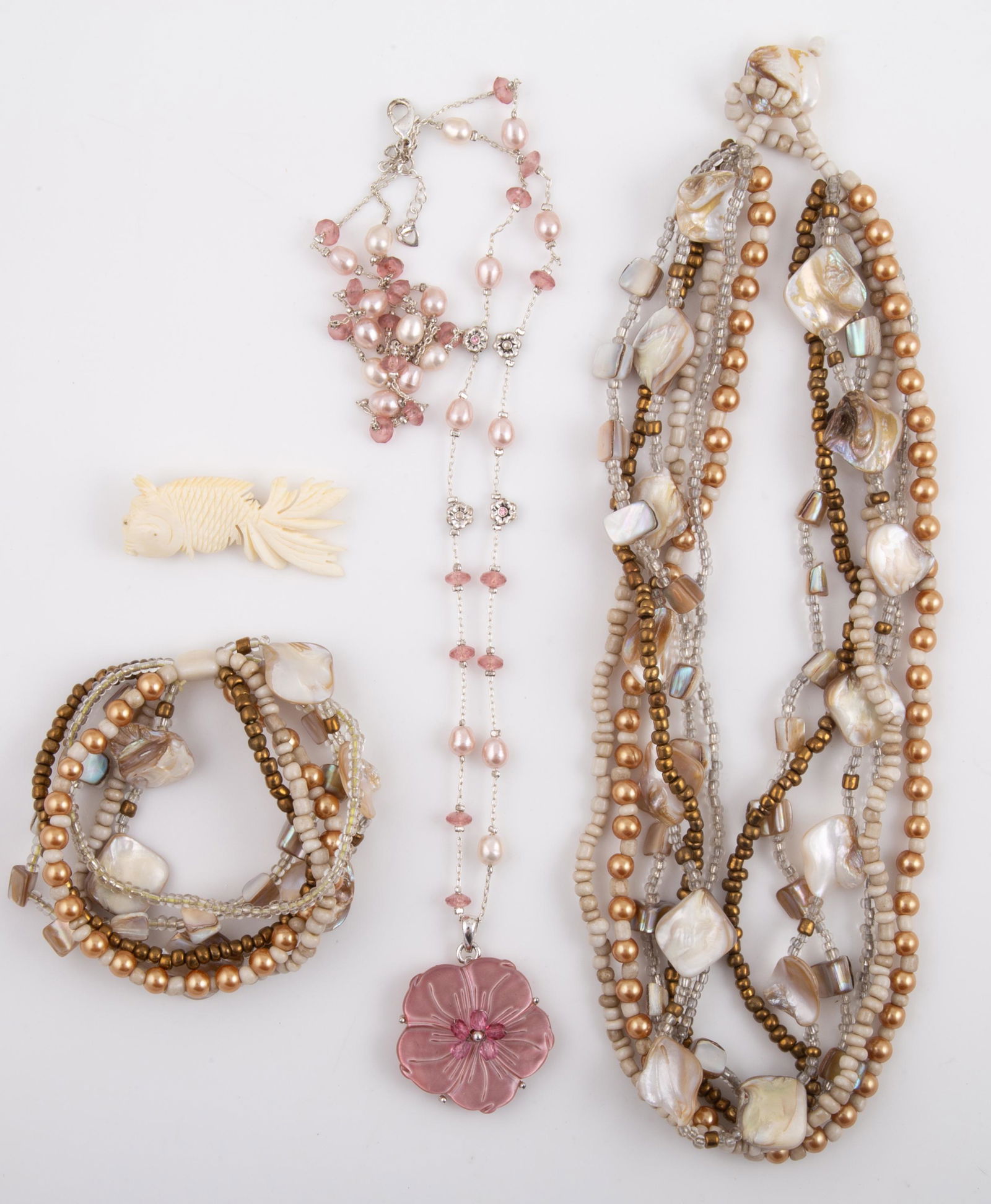 (4) PCS. CARVED SHELL, ETC. MOTHER OF PEARL JEWELRY: Includes: (1) carved shell / bone goldfish brooch, L-2"; (1) double strand necklace, silver tone chain with pink and white baroque pearls, faceted pink stones, and pink mother of pearl / shell carved