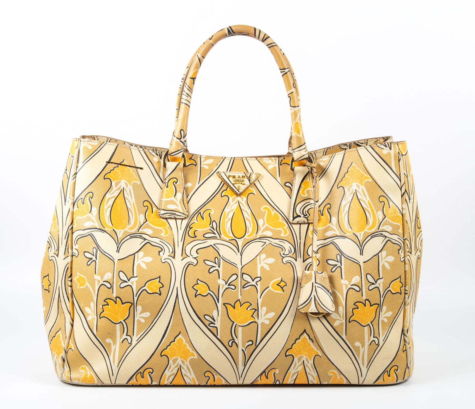 PRADA VINTAGE SAFFIANO FLORAL HANDBAG: Double handle bag with keyfob; floral orange/yellow and beige printed leather exterior; interior has several areas of cracking and flaking to synthetic leather surface; small ink mark, retains key fob