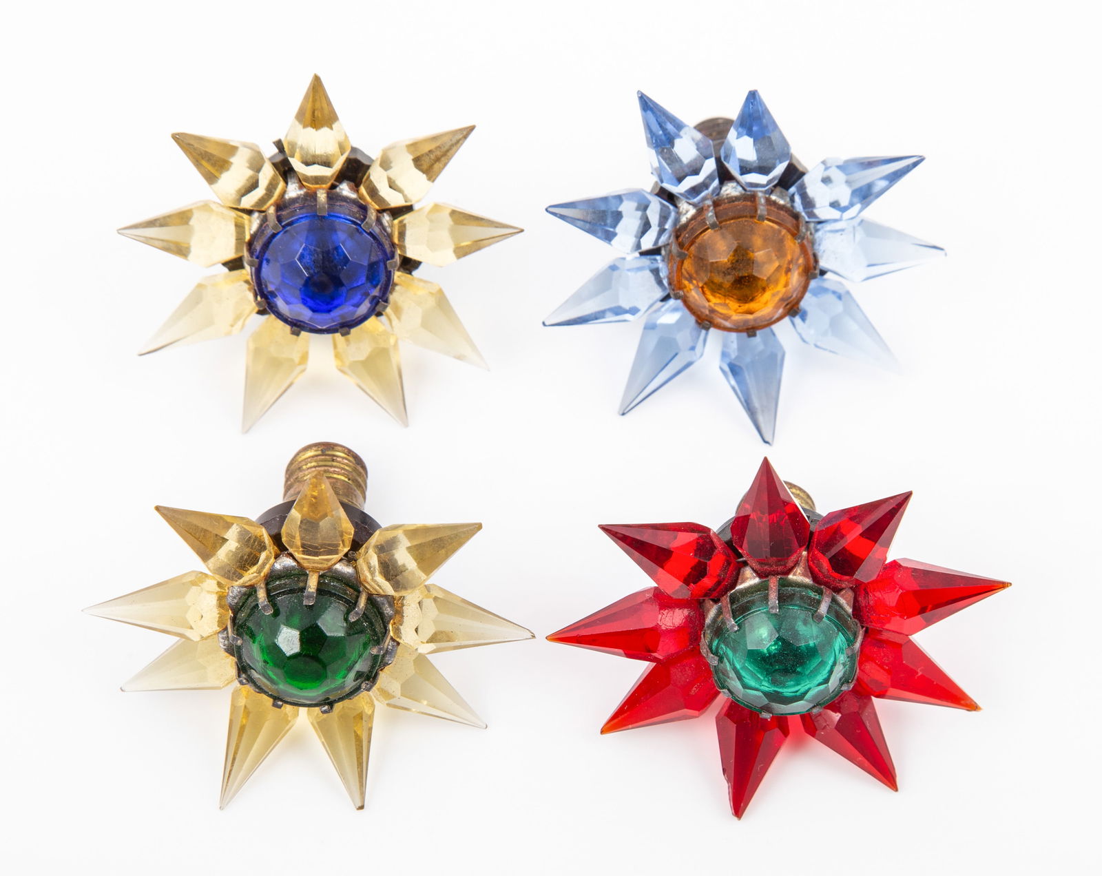 (4) MATCHLESS STAR BULBS: Includes: (1) single row Matchless star, made in USA, blue center and clear lucite rays, has conductivity, L-1 3/4"; (1) single row Matchless Star, Made in USA, green center with red lucite rays, no c