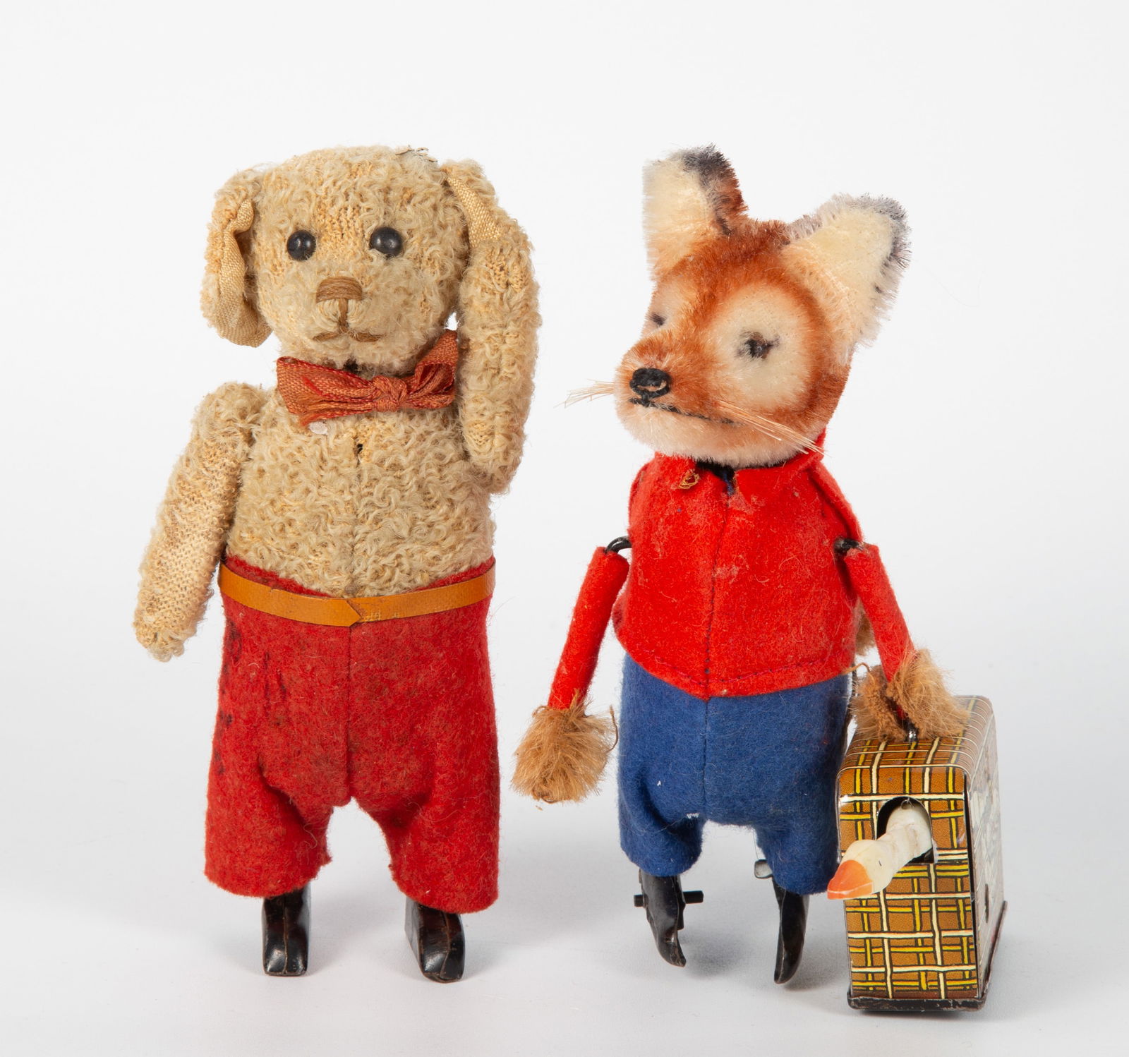 (2) VINTAGE SCHUCO TOYS: Plush mechanical key wind; Germany; (1) fox with tin litho suitcase; (1) dog; both work, no key; dog is slightly soiled and has writing on pants legs; L-5", G-EX