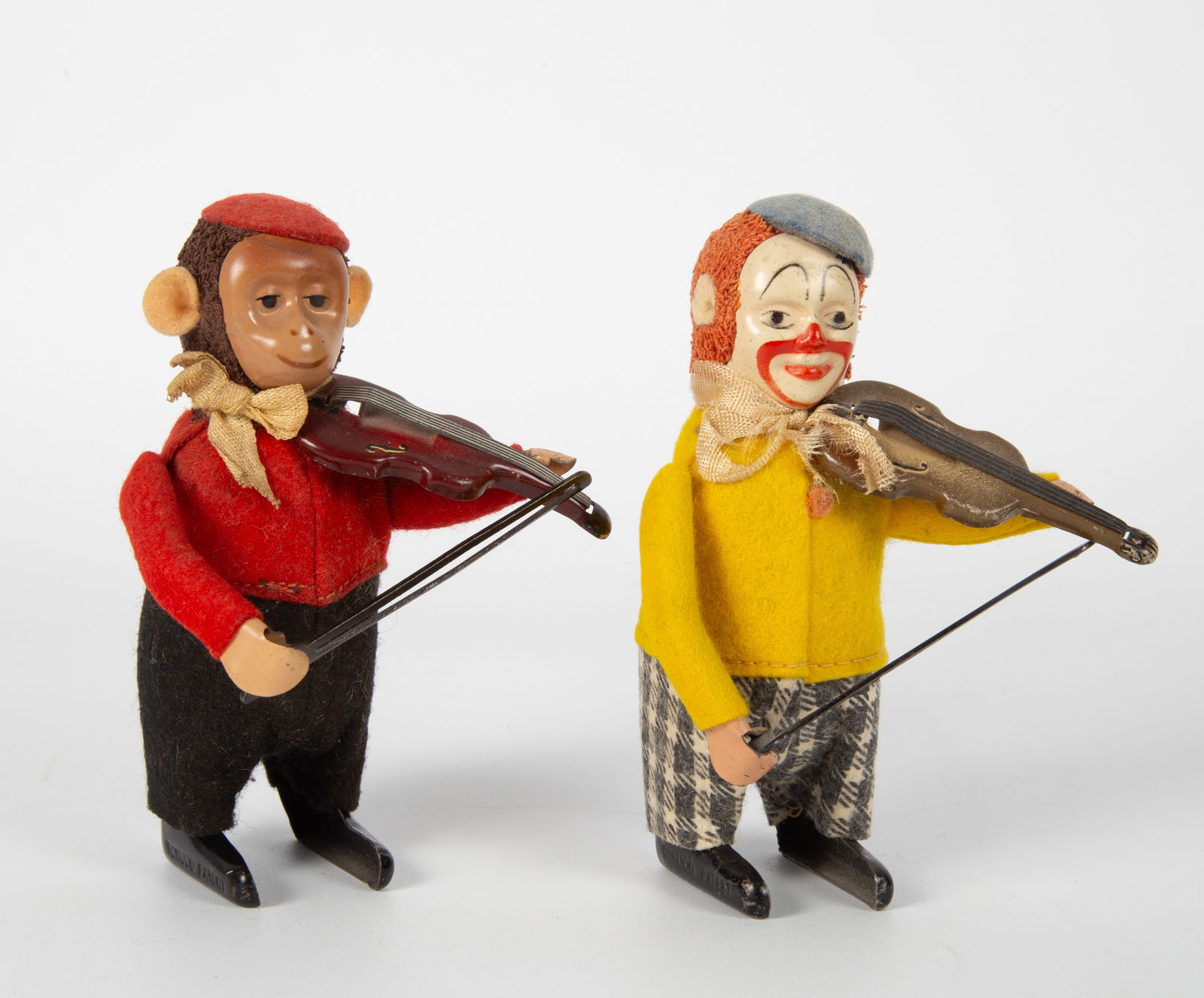(2) VINTAGE SCHUCO MUSICIANS: Germany; mechanical; wind-up; painted metal; cloth clothing; (1) monkey; (1) clown; minor wear, both working, no keys, L-4 1/4", VG-EX