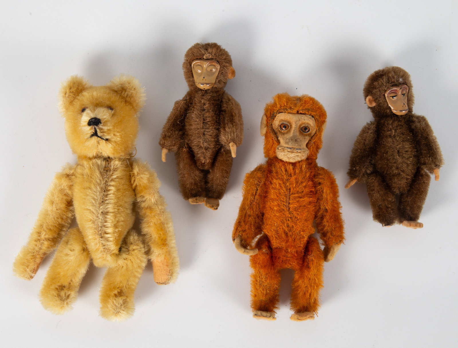(4) VINTAGE SCHUCO MONKEYS & BEAR: (3) jointed monkeys, metal and composition faces; (1) mechanical somersaulting bear; monkeys have some wear; (10 paint loss on face of (1) brown monkey; (1) foot missing on one brown monkey; mechanica