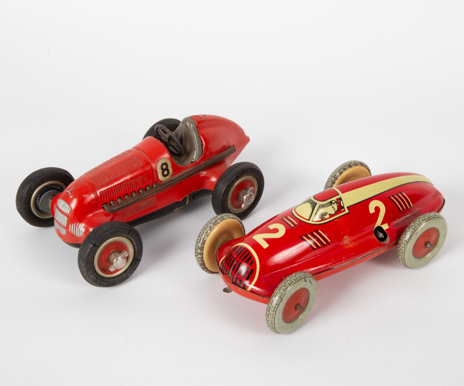 (2) U.S. ZONE GERMANY RACE CARS - SCHUCO & CLOCKWORK: (1) wind-up litho tin; steering articulated by front lever; clockwork mechanism works well; L-5 1/2"; (1) Schuco Studio 1050 race car, central rubber wheel is missing chunk of rubber; otherwise very c