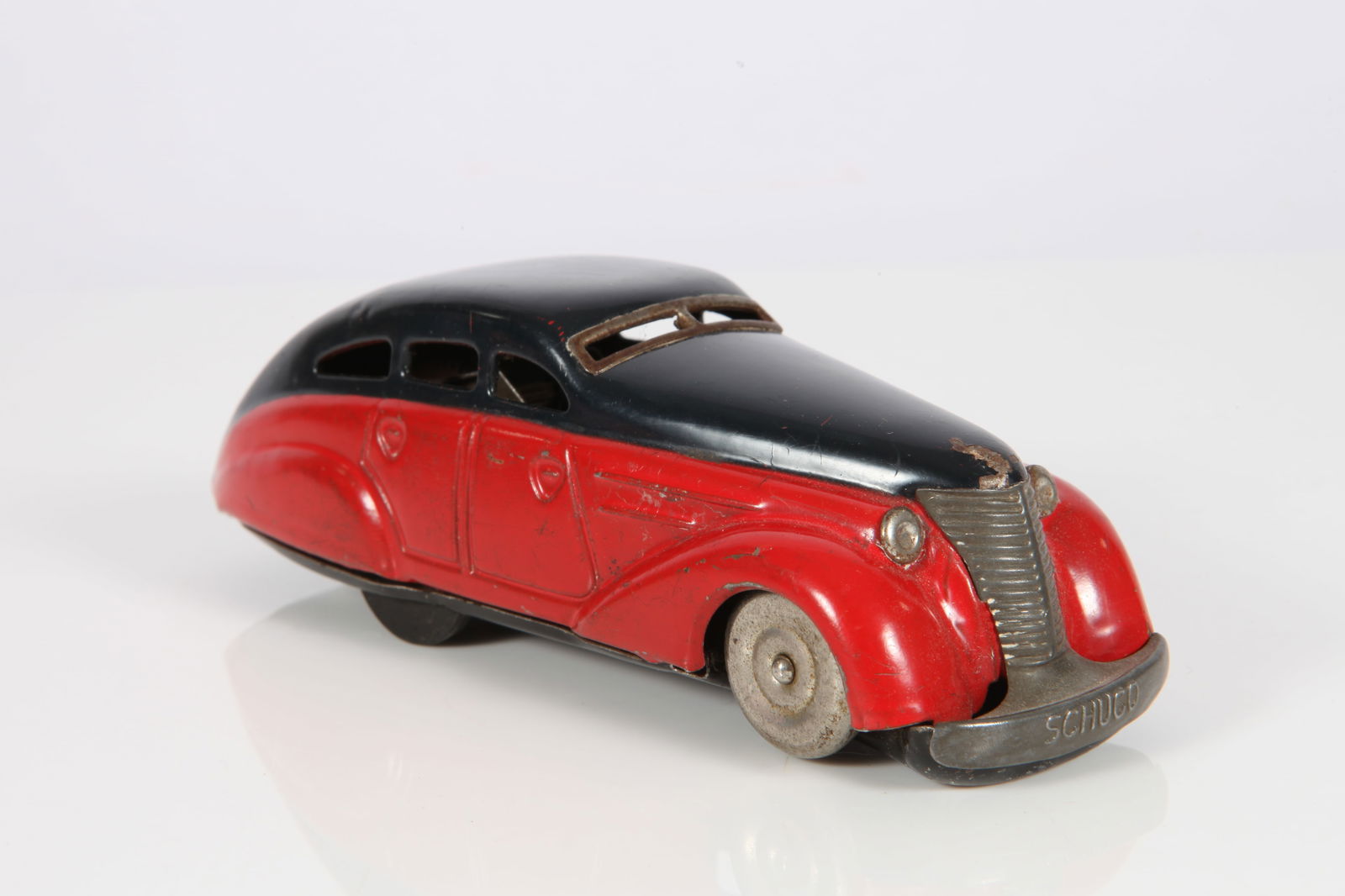 VINTAGE SCHUCO LIMOUSINE #1010: Pre-war; painted tin plate wind-up; U. S. Zone Germany; 1010 Wende Limousine; red, navy blue; runs properly; no key; minor scratches; paint loss; L-5 1/2" G-VG