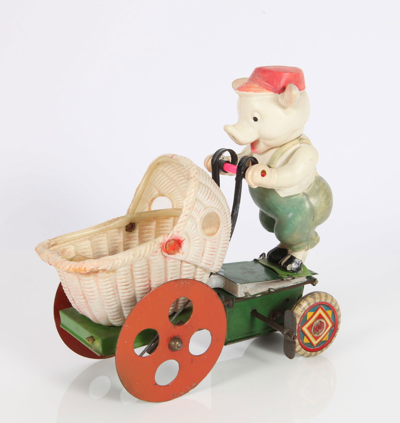 PRE-WAR JAPAN CELLULOID HAPPY PIG CELLULOID CART - CLOCKWORK: Celluloid pig pushes celluloid pram, painted and litho tin mechanism, wheels and base; clockwork mechanism and squeaker/bellows work; chicks hop up and down when pram is pushed; some fading and age ap