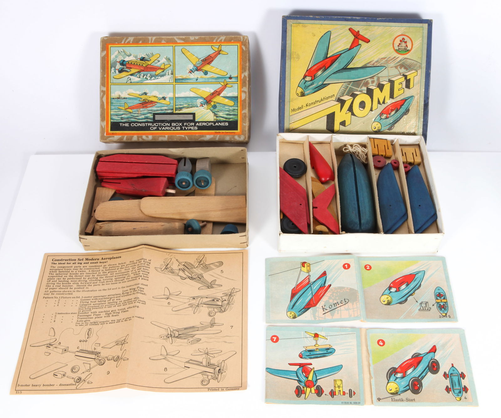 (2) WOODEN GERMAN AVIATION CONSTRUCTION SETS: KOMET, etc.: Original boxes - (1) Komet Modell-Konstruktionen boxed set, wooden airplane, retains colorful instruction booklet (torn along fold), not checked for completeness but looks fairly complete; original pa