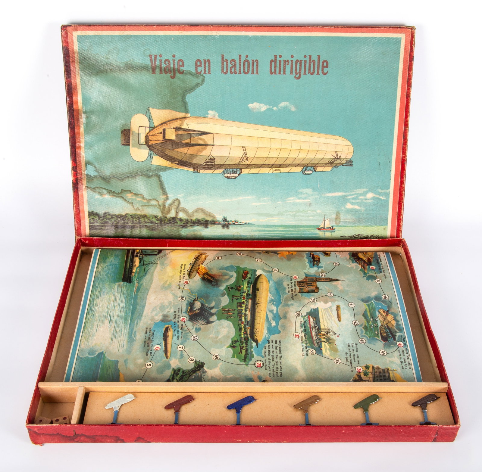SPEARS DIRIGIBLE BOARD GAME "VIAJE EN BALON DIRIGIBLE": Colorful boardgame, original box retains graphic zeppelin label (water stain / damage on left side of label and lid); game retains painted metal playing pieces, dice and colorful game board, actual ga