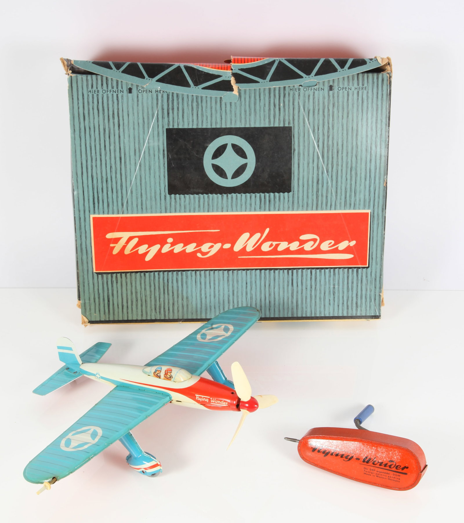 "ARNOLD" FLYING WONDER PLANE: Tin litho 1950's, crank wind; new condition; box has some wear and tear; 11 1/2" x 15 1/2" x 5", VG-EX