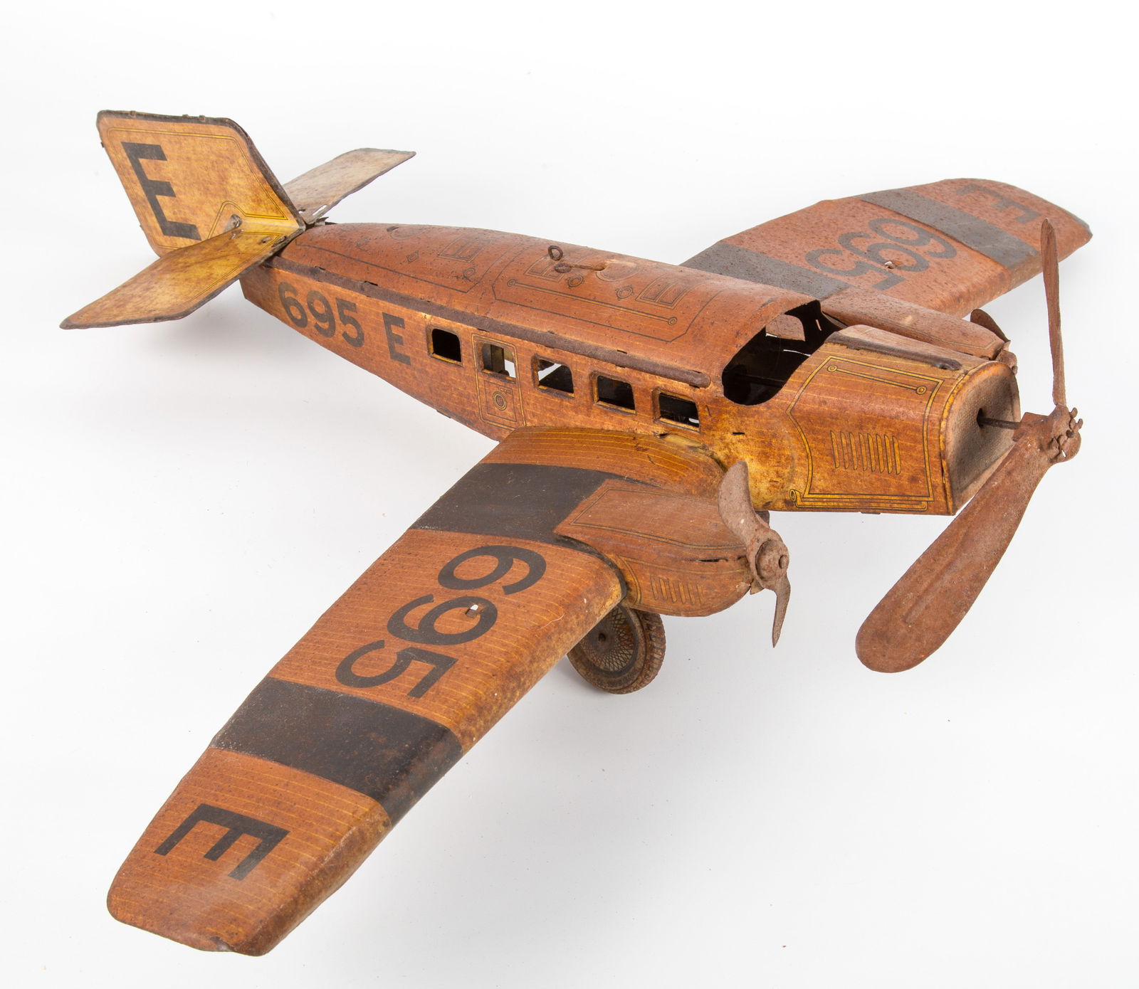 VINTAGE GUNTHERMANN AIRPLANE TOY: German; tin litho; E695 marked on wings; clockwork mechanism; all over rust; great restoration project; (1) interlocking tab on one wing is broken off; paint is spooty and dull; clockwork mechanism wo