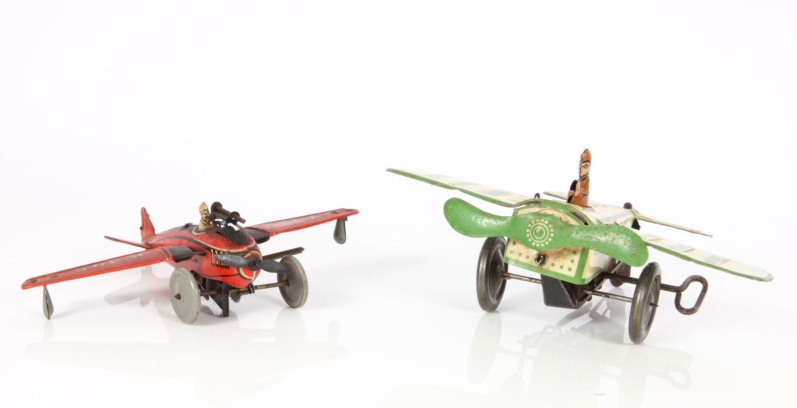 (2) WIND-UP LITHO TIN AIRPLANES: GUNTHERMANN & KELLERMAN: (1) Gunthermann litho tin wind-up airplane, mechanism working, rubs and litho loss along raised areas, missing tail rudder; wingspan L-7 1/8", total L-6"; (1) Kellerman wind-up tin litho airplane, K34