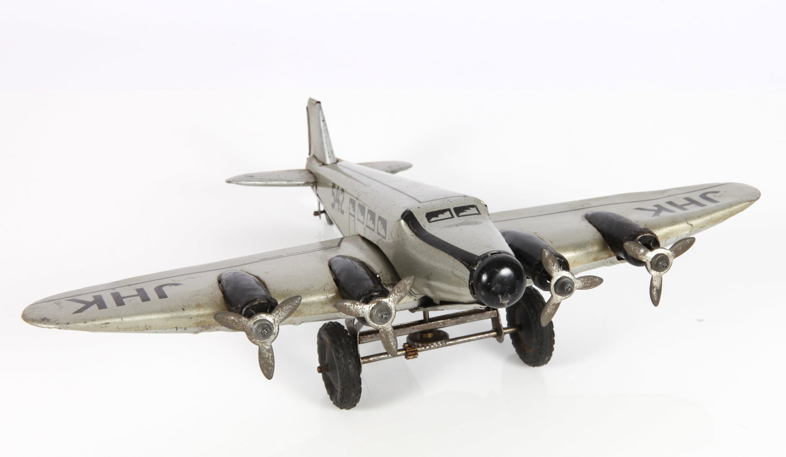 JHK HAMMERER & KUHLWEIN WIND-UP 4 ENGINE AIRPLANE: Litho tin wind-up airplane, U. S. Zone Germany; wind-up mechanism working; age appropriate wear and light scratches; some bends to end of wing; wingspan L-10"; L-8", G-VG