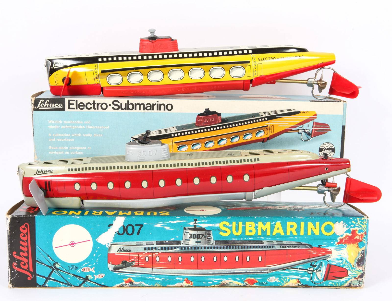 (2) SCHUCO SUBMARINO #5552 & 3007 with ORIGINAL BOXES: Includes: (1) Schuco #3007 Submarino, tin litho and plastic, wind-up mechanism, working; retains interior cardboard cushion and paperwork, no key; brightly lithographed box has litho losses, seam spli