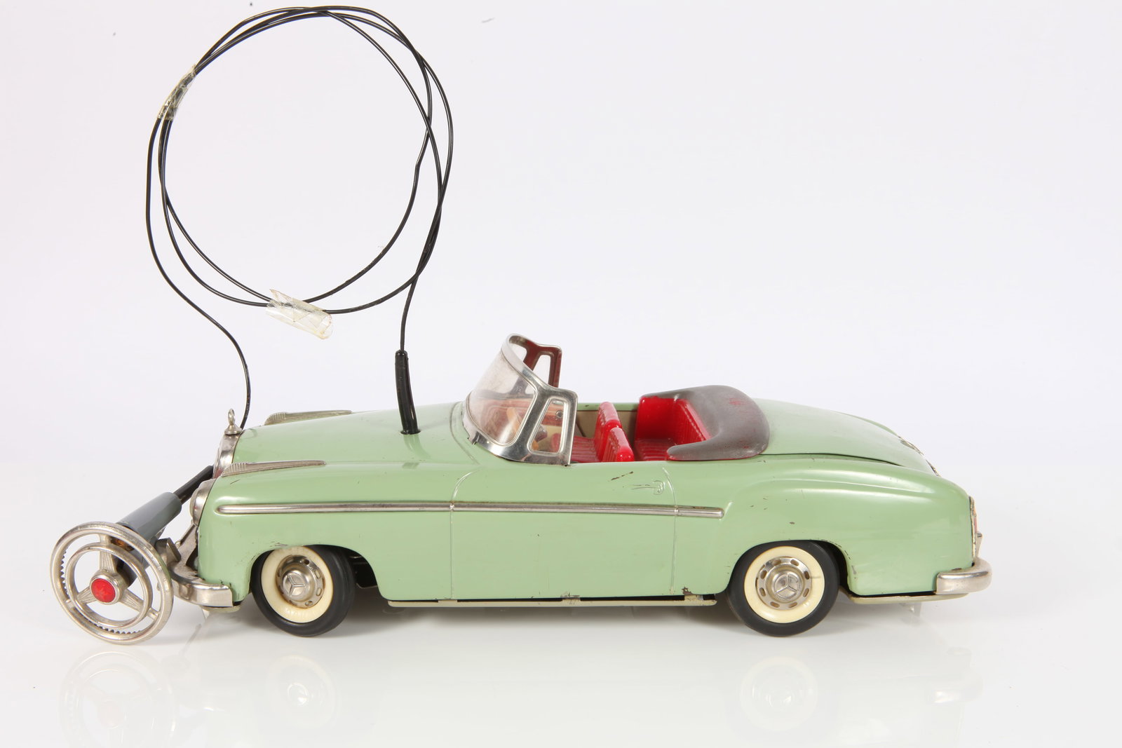 VINTAGE SCHUCO ELEKTRO HYDRO-CAR 5720: Mercedes; W. Germany; painted metal; tin litho dashboard; plastic seats and rubber tires; retains bottom portion of original box; minimal paint loss and scratches; untested; car 10", box 11 3/4", VG-E