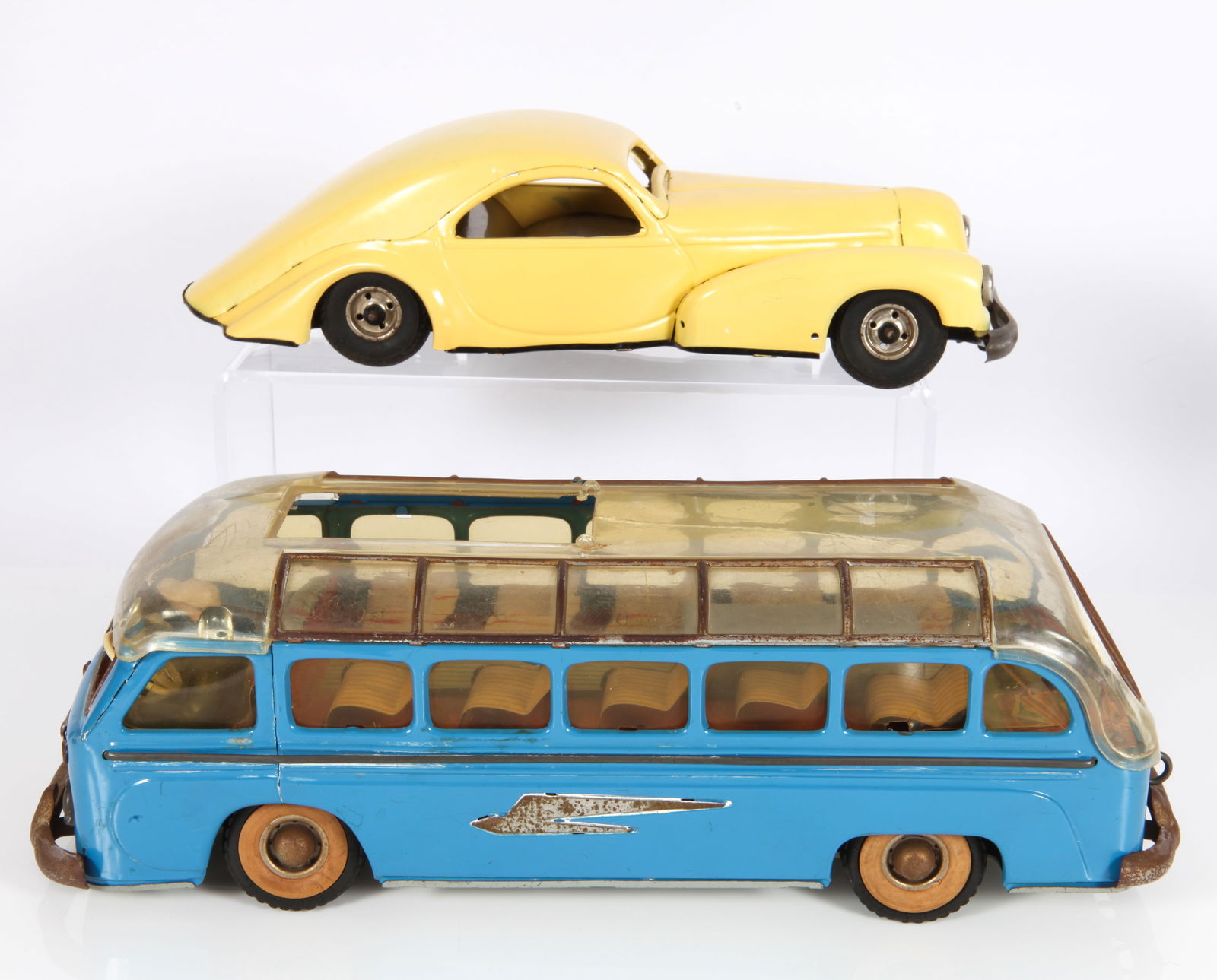 (2) GERMAN TIN WIND-UP AUTOS - GUNTHERMANN, ETC.: (1) Guntherman tin wind-up bus, tin litho interior; clear plastic top has cracks and skylight loss; mechanism working (no key); brightwork is dull, darkened and pitted, L-11 3/4"; (1) German painted t