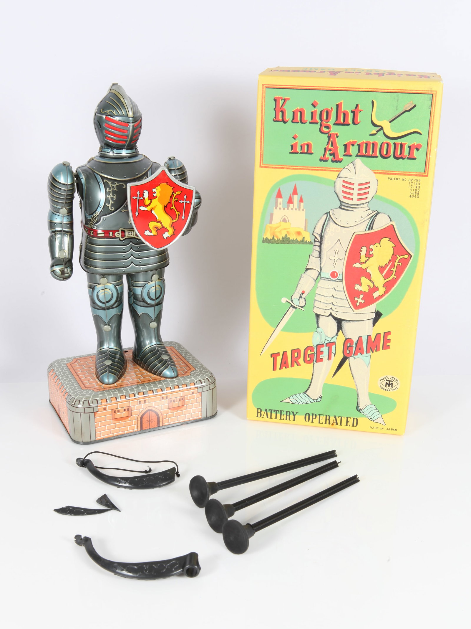 KNIGHT IN ARMOUR TARGET GAME: Tin litho battery op by Modern Toys, original box, Japan; interior of box is stamped "Dozier Designs Replica"; knight is very clean and has little to no wear; comes with (3) plastic suction arrows and