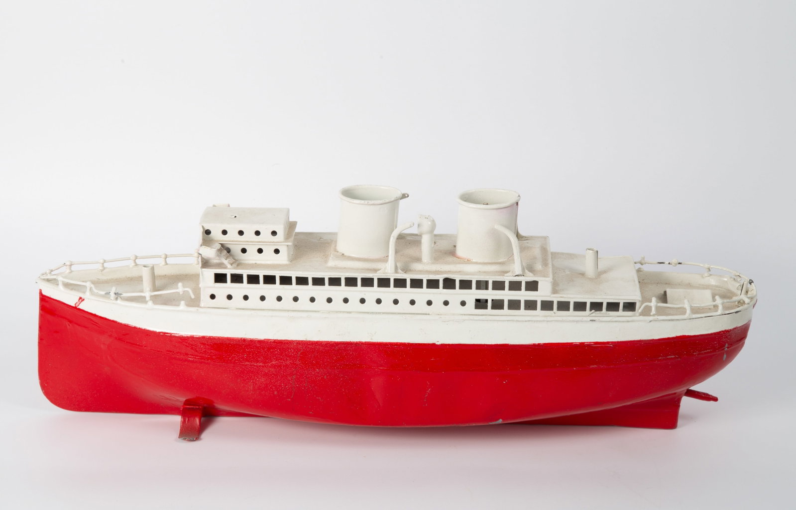 VINTAGE PASSENGER SHIP TOY: Painted metal, key wind, likely Fleischmann - German; good candidate for restoration; repainted; clockwork mechanism is not working; body has dent and minor damages; missing parts; no key; L-16", F-G