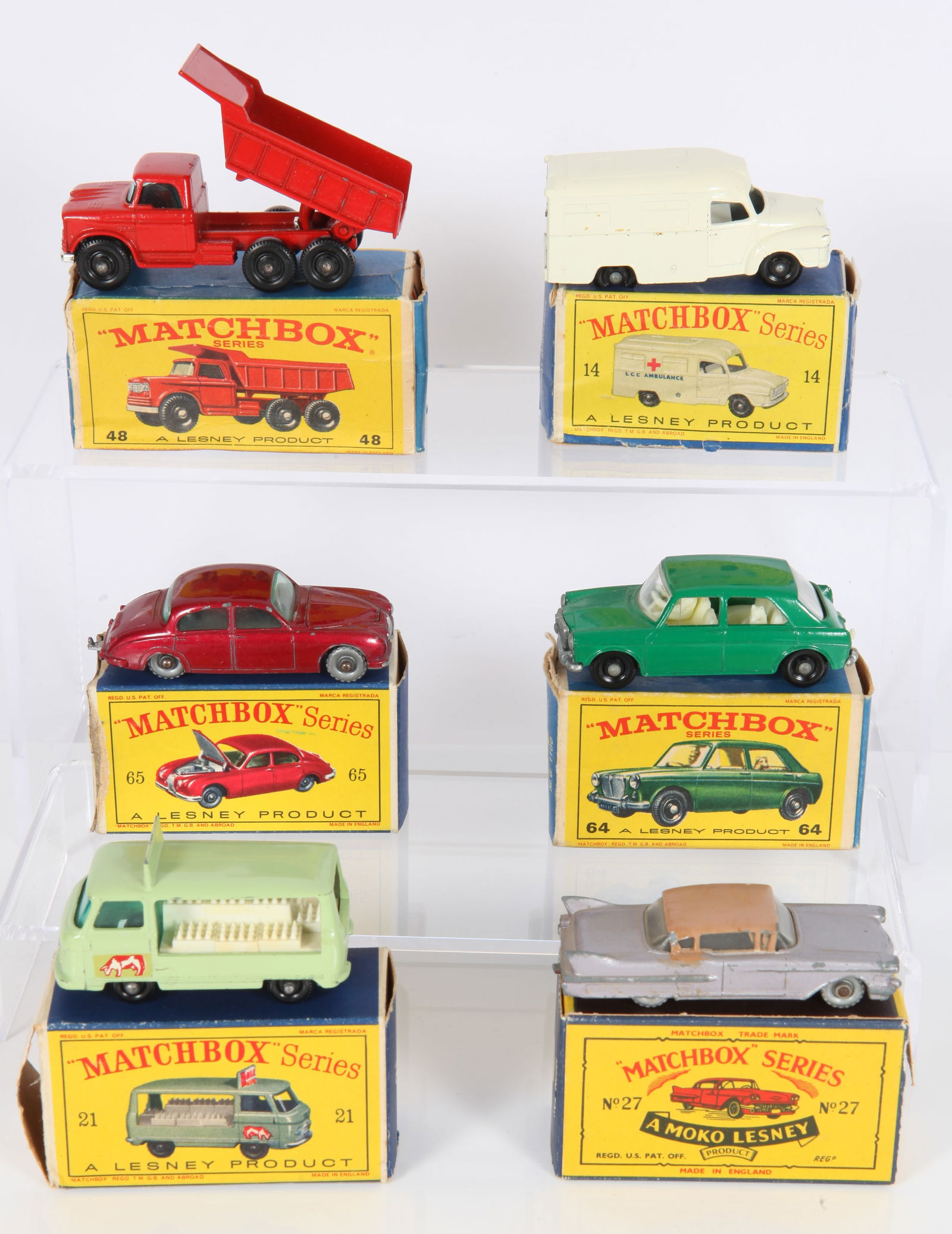 (6) MATCHBOX LESNEY TOY VEHICLES - ORIGINAL BOXES: England; Diecast 1:64; 1-Green MG 1100 #64; (1) red Dodge Dumper truck #48; (1) milk delivery truck #21; (1) Lomas ambulance #14; (1) red Jaguar 3-8 sedan #65; (1) Cadillac "Moko", silver with tan roo