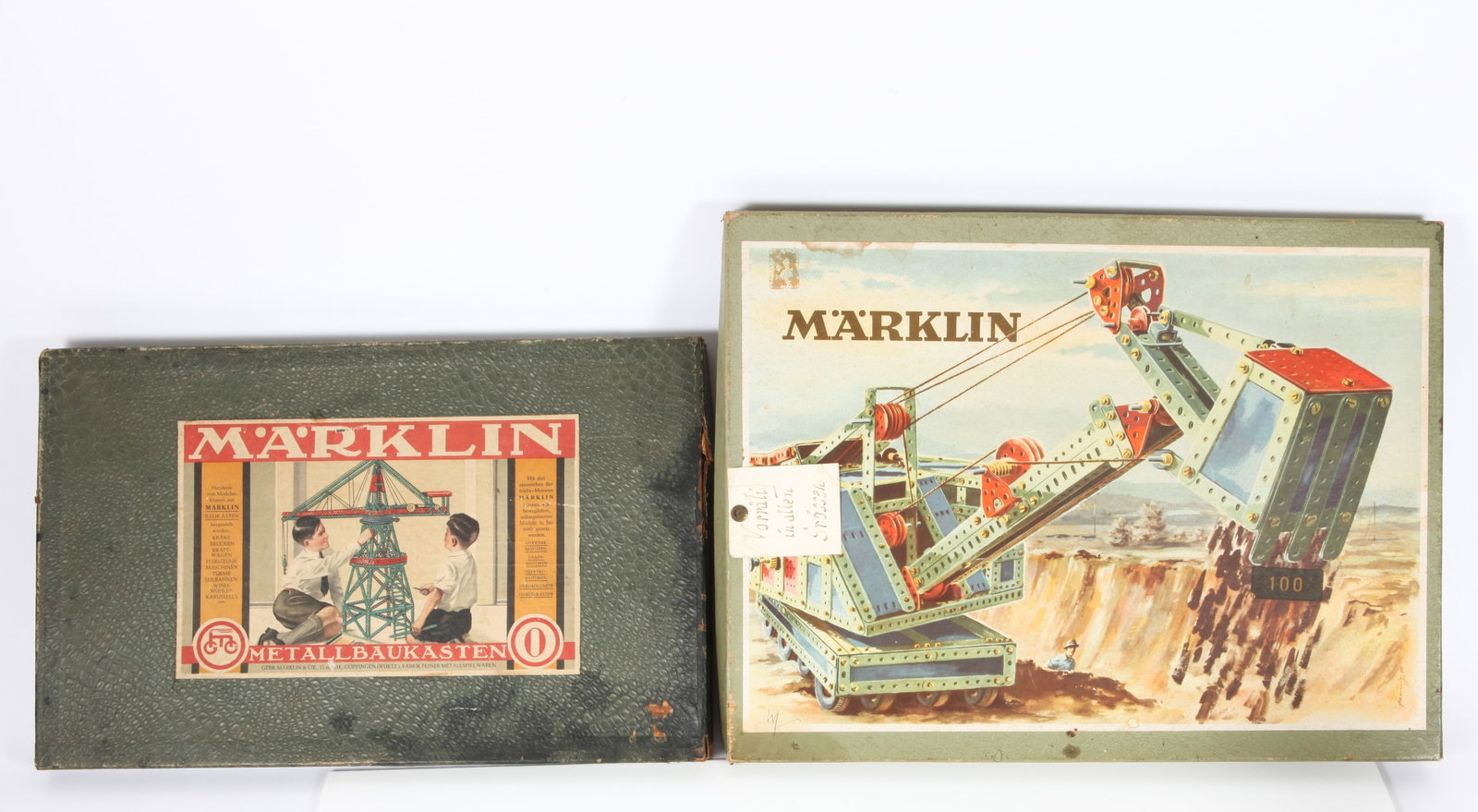 (2) MARKLIN METALLBAUKASTEN SETS #0 and #100: (1) Metallbaukasten set #0, at a glance the set appears complete, but not certain; retains original paperwork, some pieces have paint losses and wear; original box lid has split to apron, wear and tea