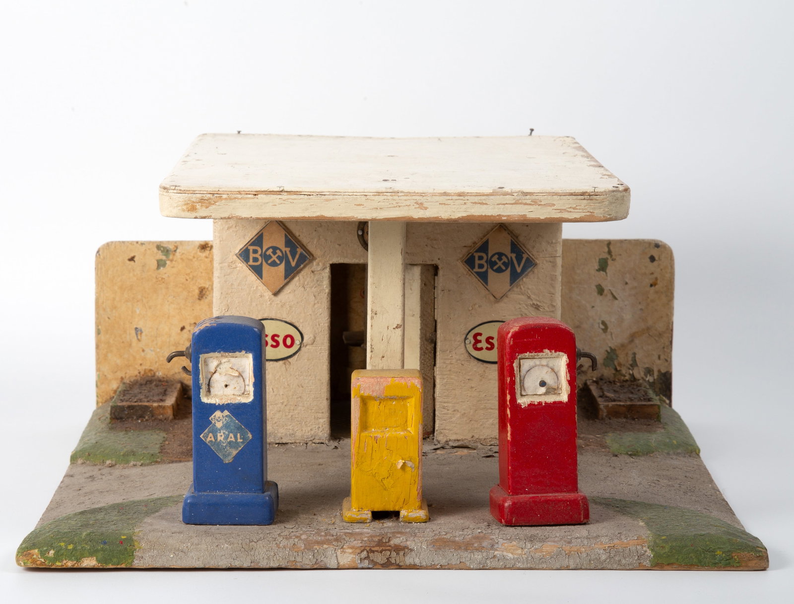 FOLK TOY GAS STATION: Handmade, painted wood with three gas pumps, station building has hinged door and glass windows; exterior of building has "Esso" and "BXV" signs and clock; good candidate for restoration, paint flakin