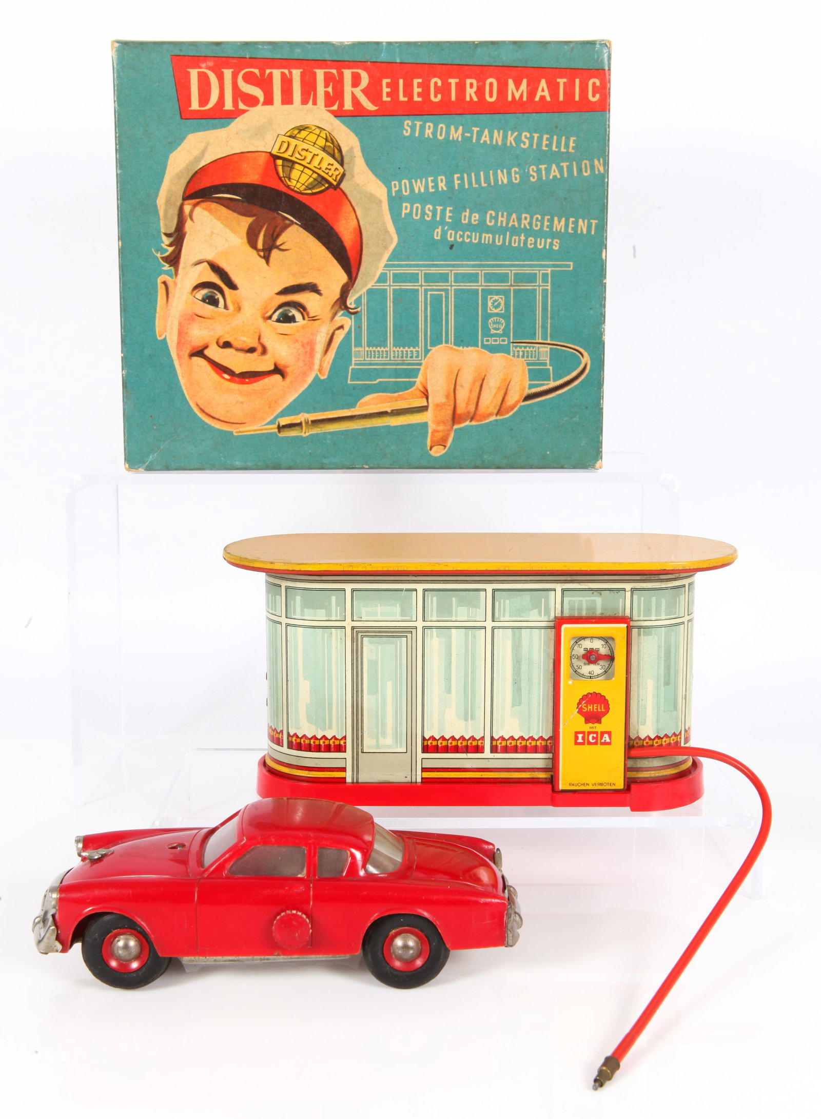 DISTLER ELECTROMATIC POWER FILLING STATION with ORIGINAL BOX: Plastic and tin litho battery powered filling station; Shell logo (scratch to litho by logo); untested; with red plastic and metal Jaguar, car shows age wear, crack in rear window; colorful litho box;