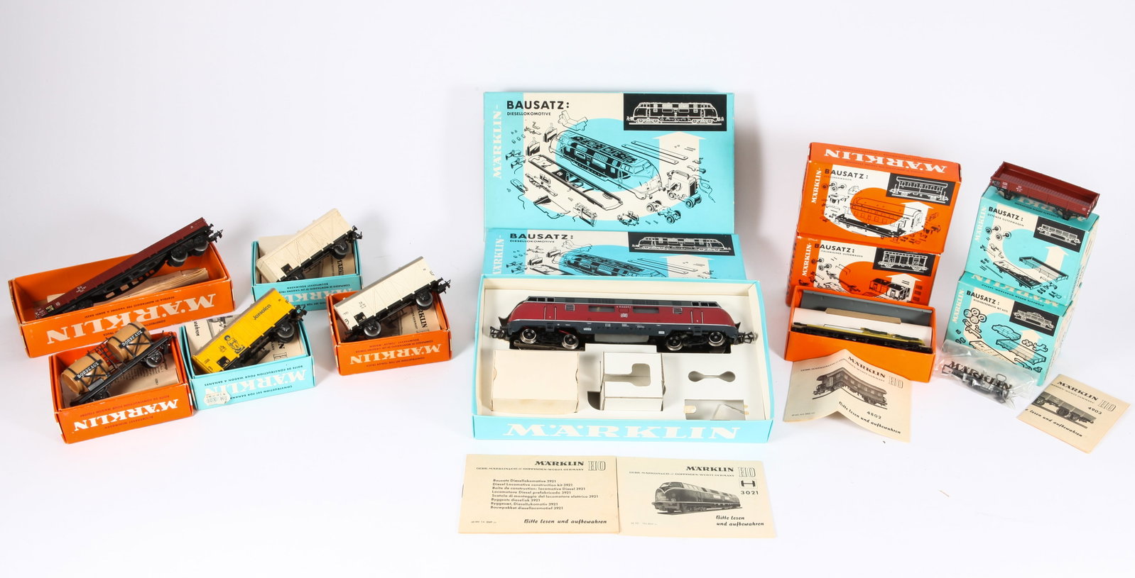 (12) MARKLIN HO ENGINE / CAR CONSTRUCTION KITS with ORIGINAL BOXES: Includes: (2) #3921 Bausatz diesel locomotives, both built with original box and paperwork; (1) #4802 passenger car, unbuilt with original box and paperwork; (2) #4910 wine truck, 1-built and 1-unbuil