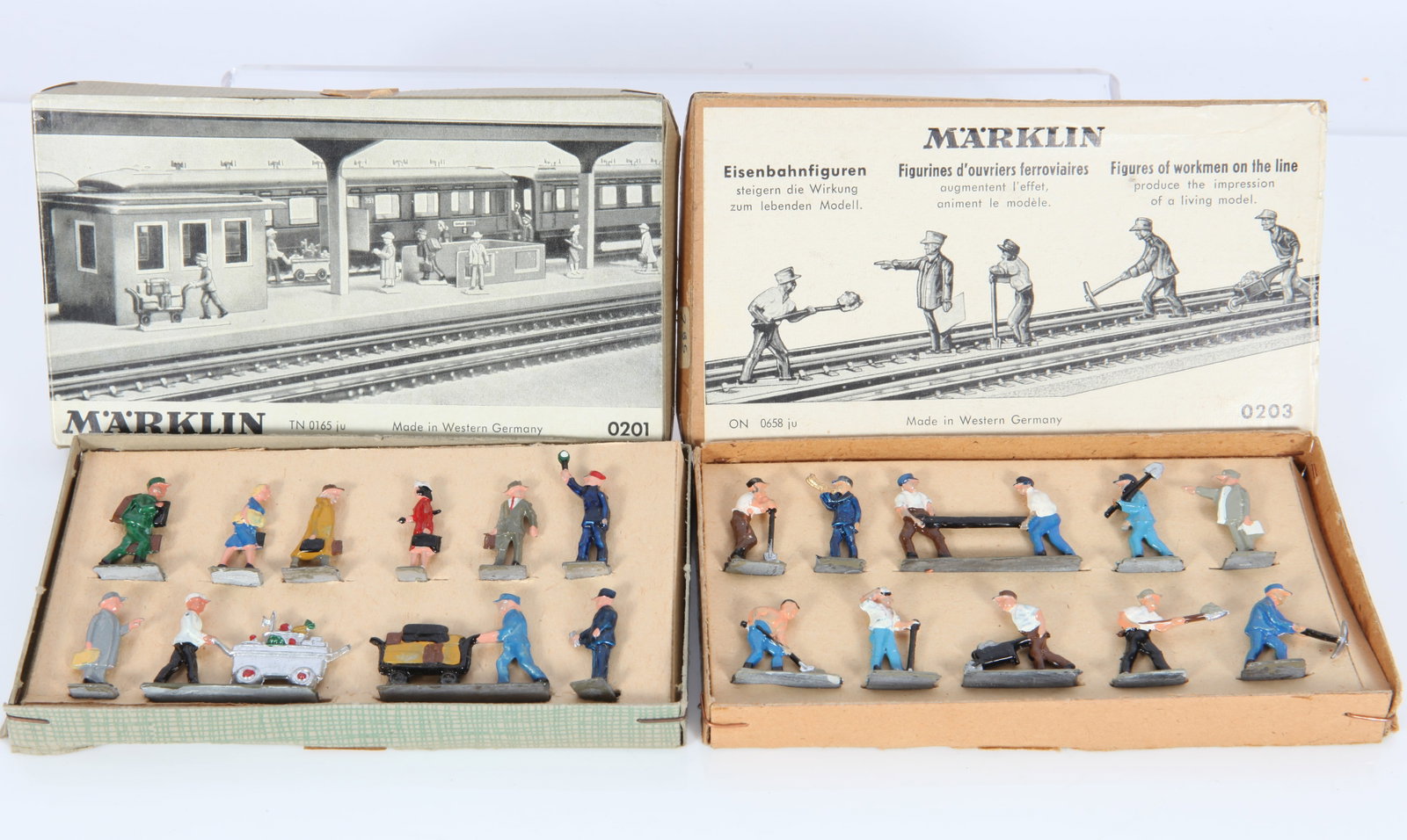 (2) VINTAGE MARKLIN HO FIGURE SETS - ORIGINAL BOXES: New in boxes; painted metal; (1) 0201 (10) station figures; (1) 0203 (10) railroad workers; 4 3/4" x 2 2/3" x 1/4" high; EX-NM