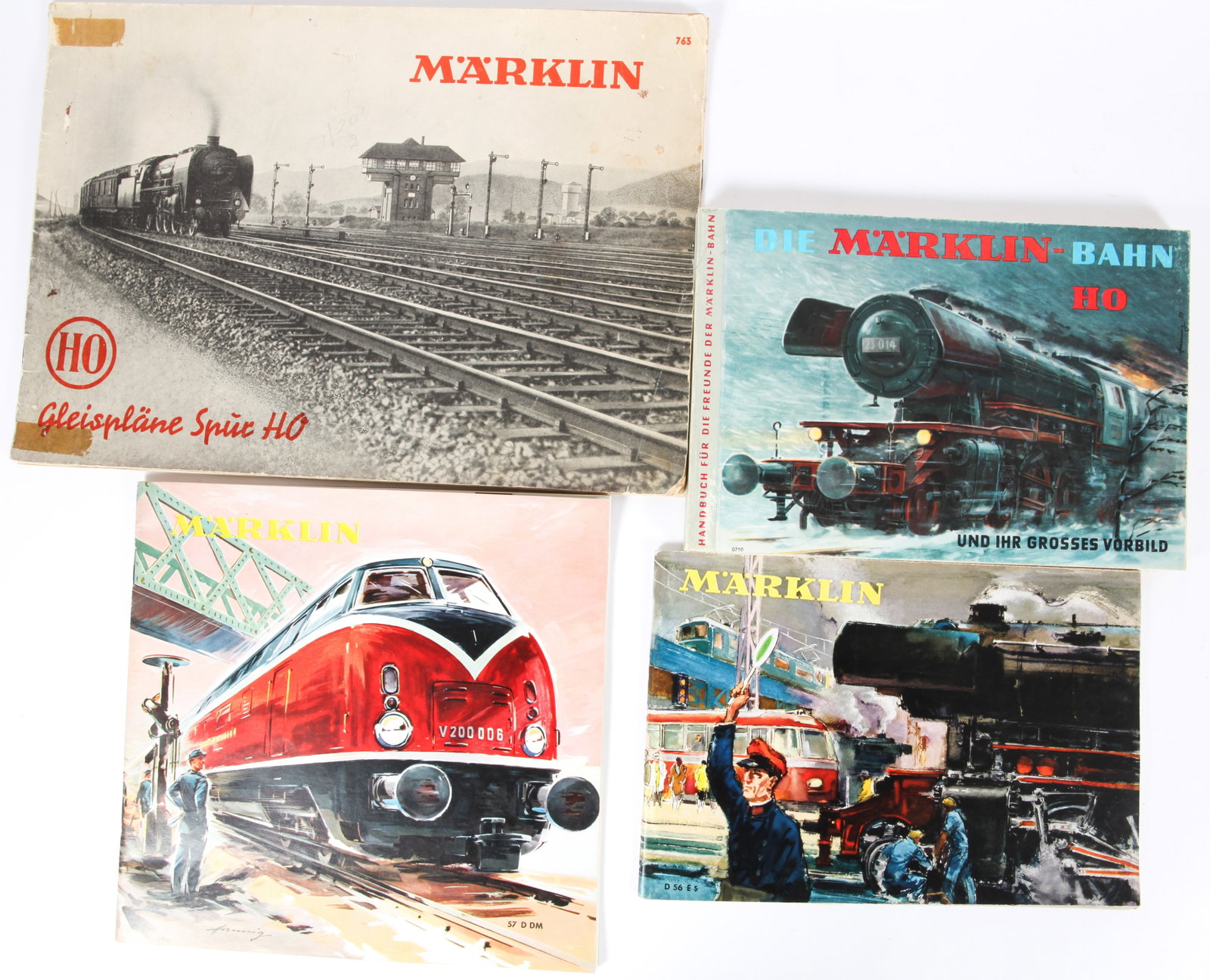 (4) 1950'S & 60'S MARKLIN TRAIN CATALOGS - HO GAUGE: 1954 #763, 1956 D56E, 1957 57D DM, 1960'S #310; 1954 catalog has creases, tape residue, toning, weak binding, minor stains; largest 11 3/4" x 8 1/4", F-VG