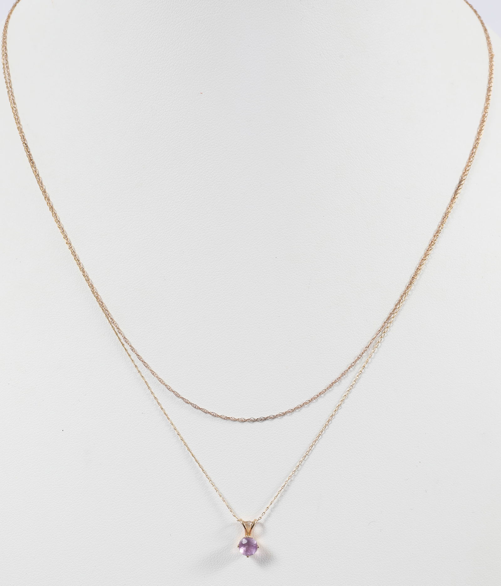 (2) GOLD CHAINS & AMETHYST DROP: (1) 14K yellow gold chain with .5 carat +/- round amethyst lavender drop, L-19 3/4", .56 dwt total; (1) 10K yellow gold chain, .33 dwt, L-18", VG-EX