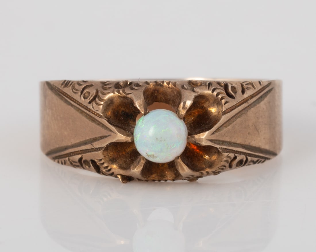 VICTORIAN GOLD and OPAL BAND: Yellow gold, marked on inside: K {star} marking; central opal, round .25 carat cabochon opal; openwork setting; size 7; [1.67 dwt total],
