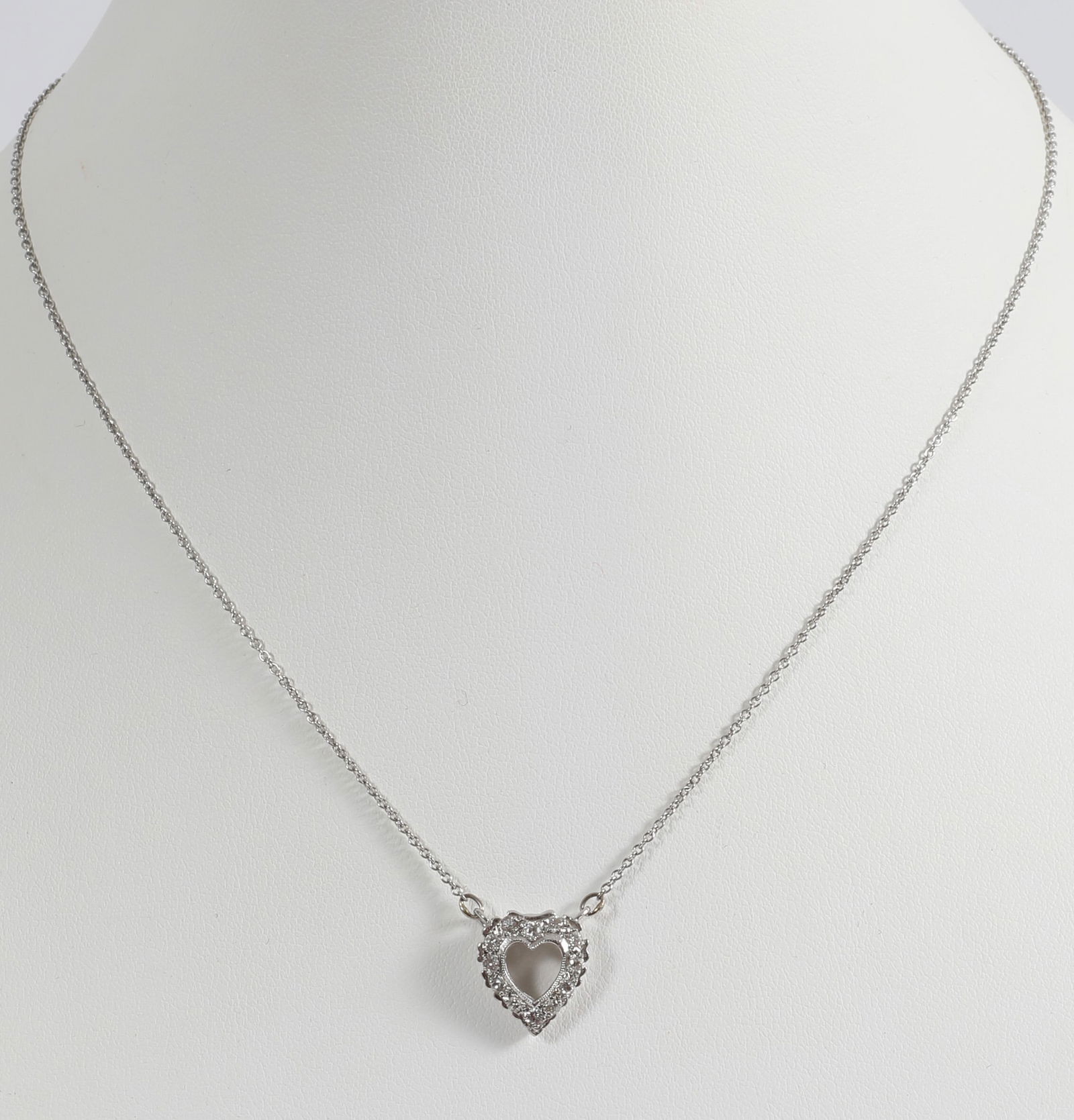 14K WHITE GOLD & DIAMOND HEART NECKLACE: White gold fine link chain necklace with central heart pendant, set with (12) round .02 carat +/- diamonds; [1.8 dwt total], L-16", VG-EX