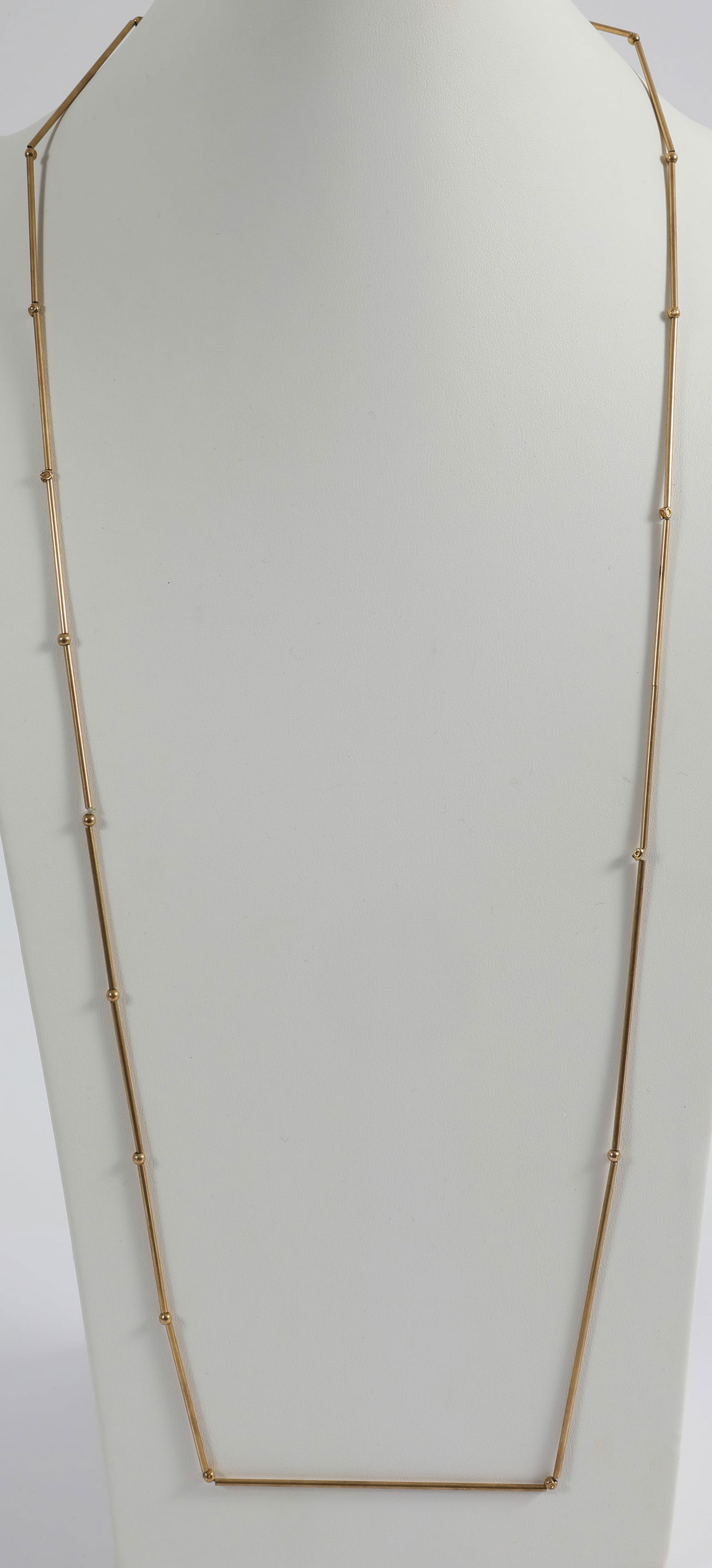 14K GOLD MODERNIST NECKLACE: Of the style of Betty Cooke, tubular beads of varying lengths interspersed with tiny small round beads; unsigned; several of the round beads have dents, one tubular bead is split, L-36 1/2"; [8.04 dwt