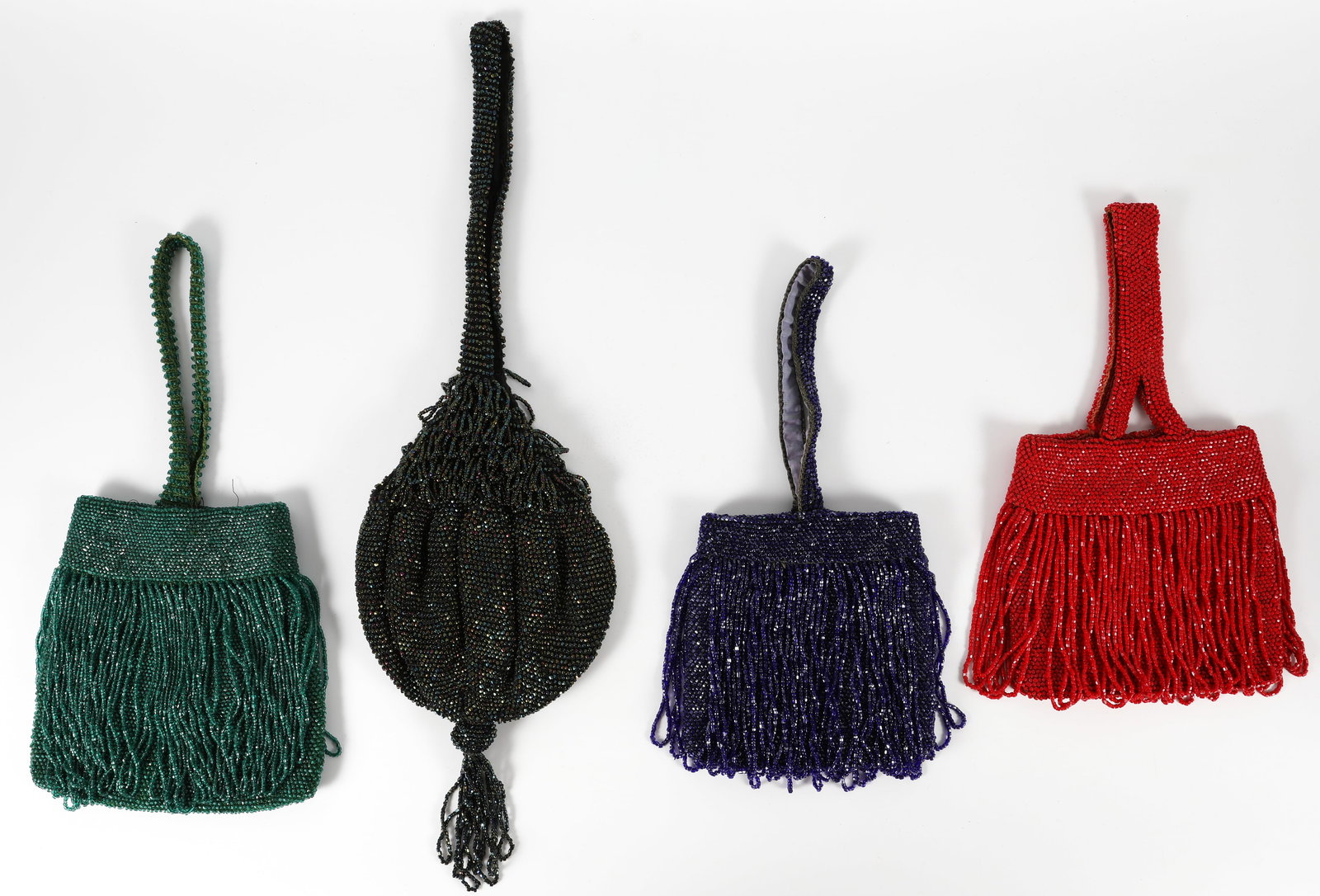 (4) VINTAGE BEADED HANDBAGS: Each bag with beaded fabric handles; (1) green, snap closure; some fringe bead loss; bag is lined with satin (likely re-lined); length with handles 13"; (1) dark green iridescent beaded bag; tassel bo