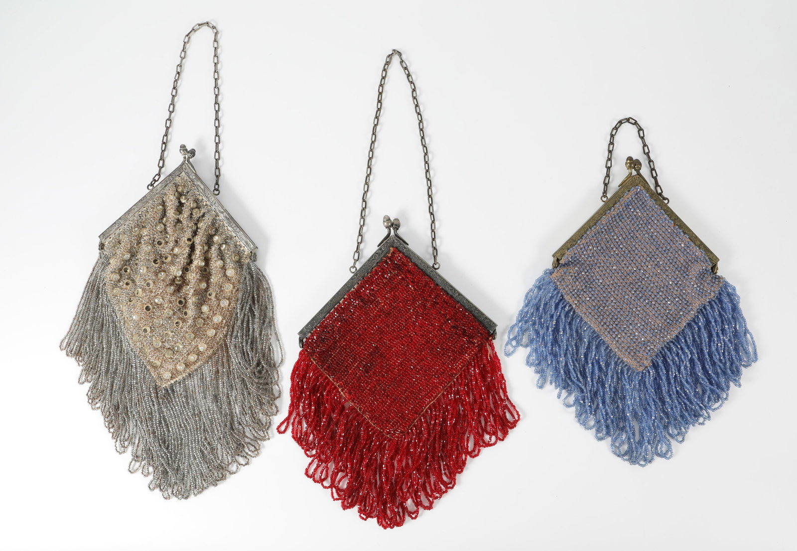 (3) VINTAGE BEADED HANDBAGS: Each bag fitted with chain handles; each with triangular metal frame / closure; (1) silver/clear beaded bag, each side featuring larger beads with central rhinestones; 1-side rhinestones are all intac