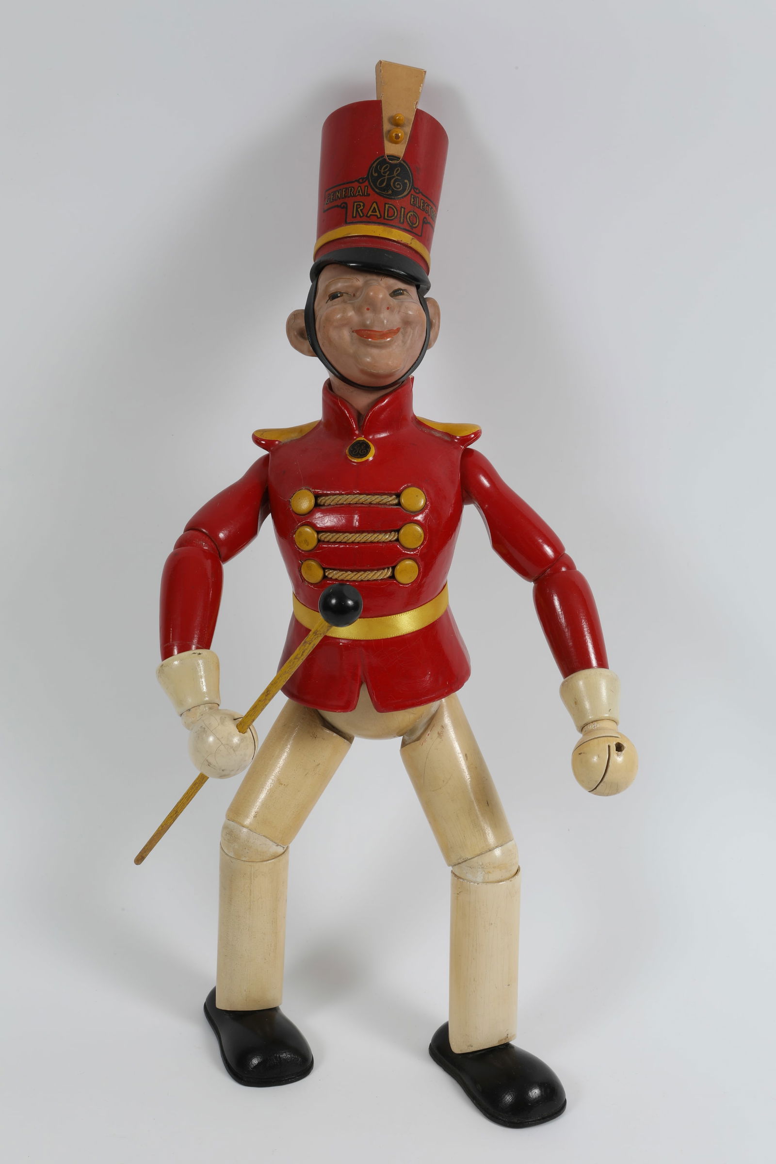 1930's GENERAL ELECTRIC RADIO "BANDY" ADVERTISING FIGURE: Cameo Products; wood and composition figure; retains original decals on hat, chest; Cameo products label on bottom of foot; some light crazing to painted surfaces; missing (1) baton; L-18 3/4", VG+