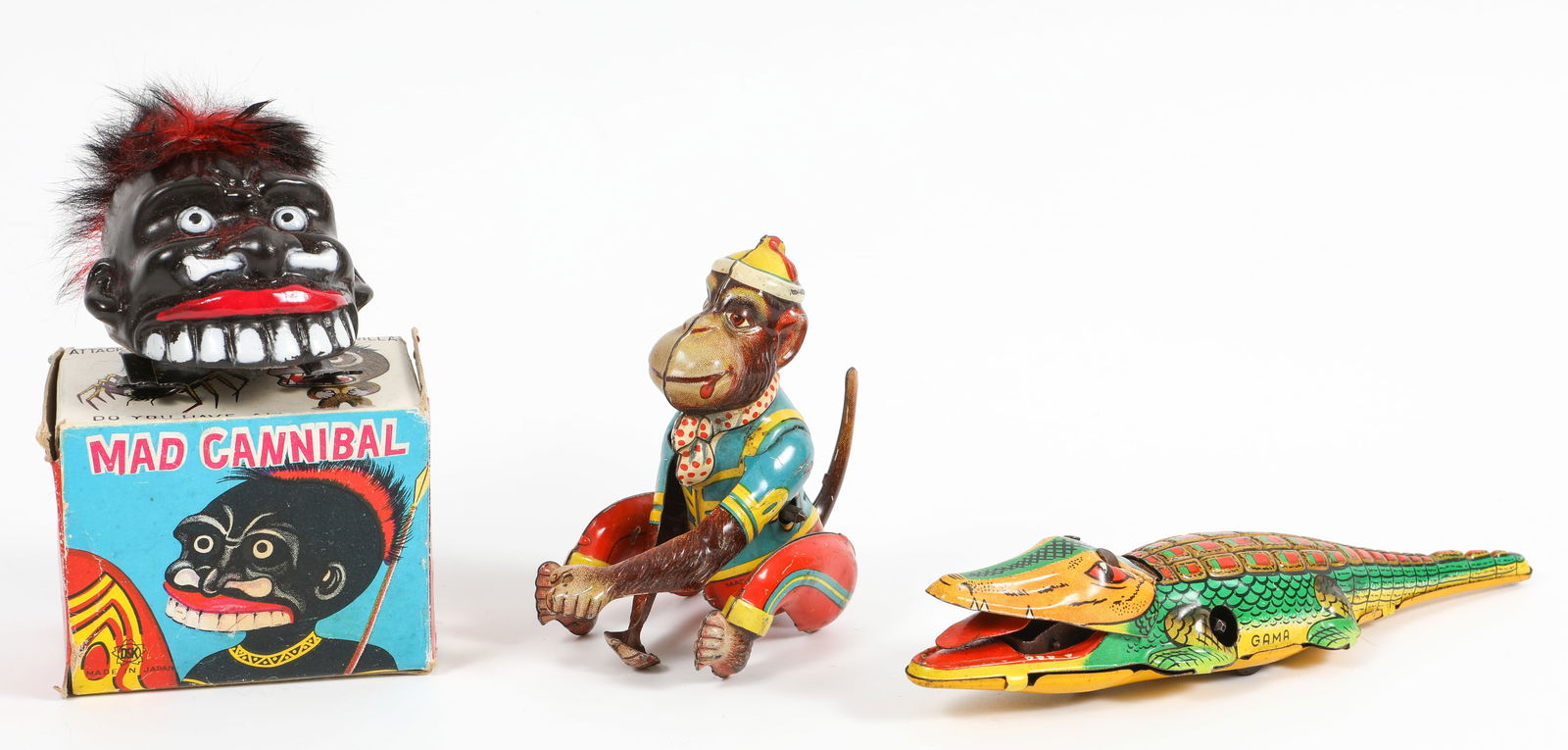 (3) WIND-UP TOYS: GAMA CROCODILE, DSK MAD CANNIBAL, ETC.: (1) "Mad Cannibal" wind-up toy with original box, DSK Made in Japan; mechanism working; "hair" is shedding, otherwise VG, original box has some age wear, mainly to edges; box: 2 1/8" x 2 5/8", (1) cli